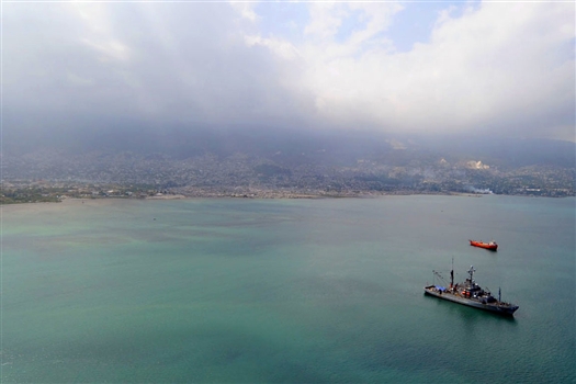 The Military Sealift Command rescue and salvage ship USNS Grasp is at anchor in the Port-Au-Prince harbor as divers work on the city's pier, March 16, 2010. Divers embarked aboard Grasp and divers from Mobile Diving Salvage Unit 2 are repairing the pier after a 7.0 magnitude earthquake struck the Port-Au-Prince area Jan. 12, 2010.