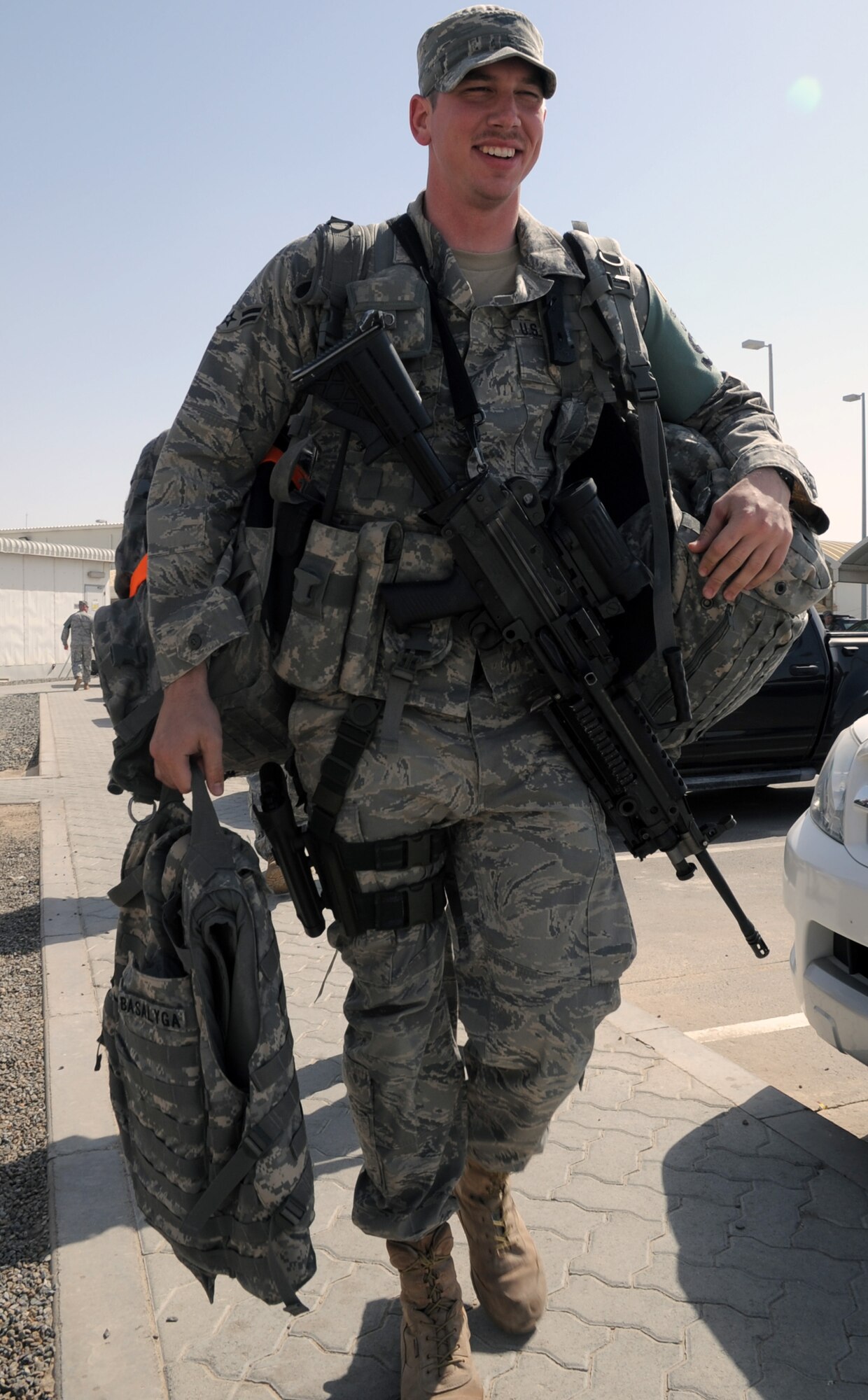 Airman 1st Class Philip Basalyga, a security forces apprentice with the 380th Expeditionary Security Forces Squadron, carries equipment to a vehicle during operations at a non-disclosed base in Southwest Asia on March 19, 2010. He is deployed from the 21st Security Forces Squadron at Peterson Air Force Base, Colo., and his hometown is Columbia, Tenn. (U.S. Air Force Photo/Master Sgt. Scott T. Sturkol/Released)