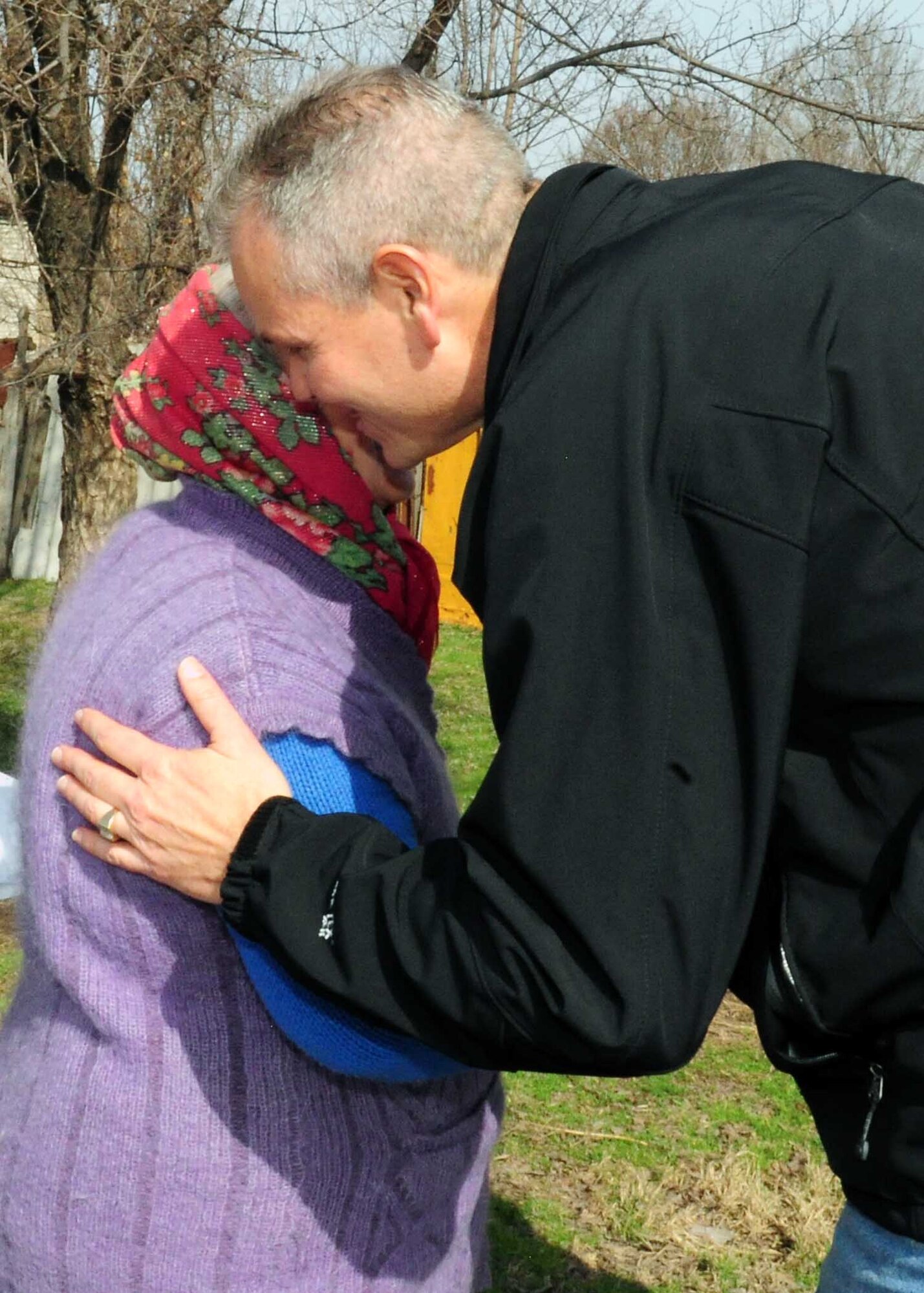 U.S. Air Force Lt. Col. Rex Vanderwood, 376th Expeditionary Mission Support Group deputy commander, hugs a ?babushka? (a respected elderly lady) in Manas Village, Kyrgyzstan, March 18, 2010. (U.S. Air Force photo/Staff Sgt. Carolyn Viss/released)