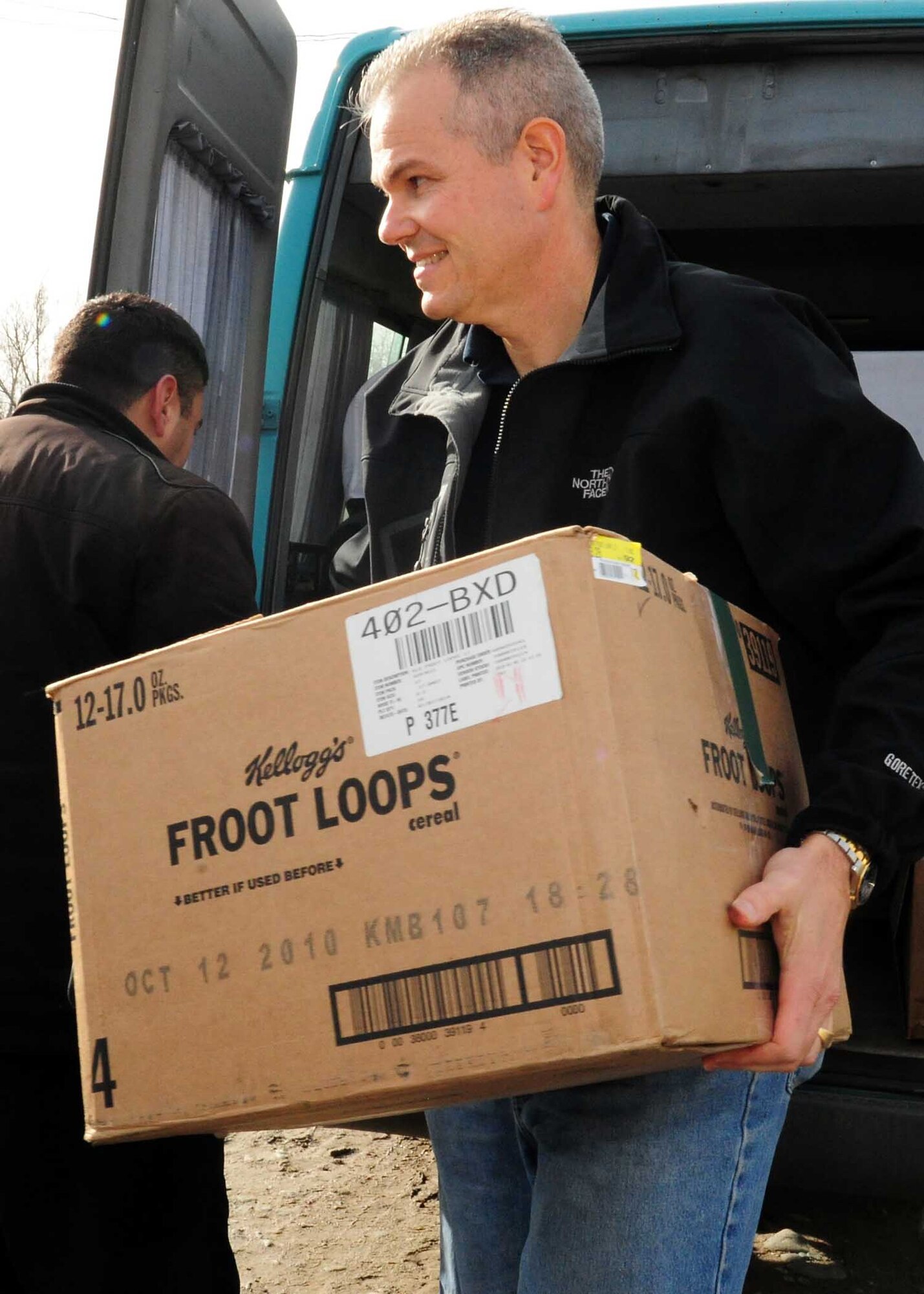 U.S. Air Force Lt. Col. Rex Vanderwood, 376th Expeditionary Mission Support Group deputy commander, unloads a box of humanitarian assistance items he collected from stateside bases and friends to distribute to families in Manas Village, Kyrgyzstan, March 18, 2010. (U.S. Air Force photo/Staff Sgt. Carolyn Viss/released)