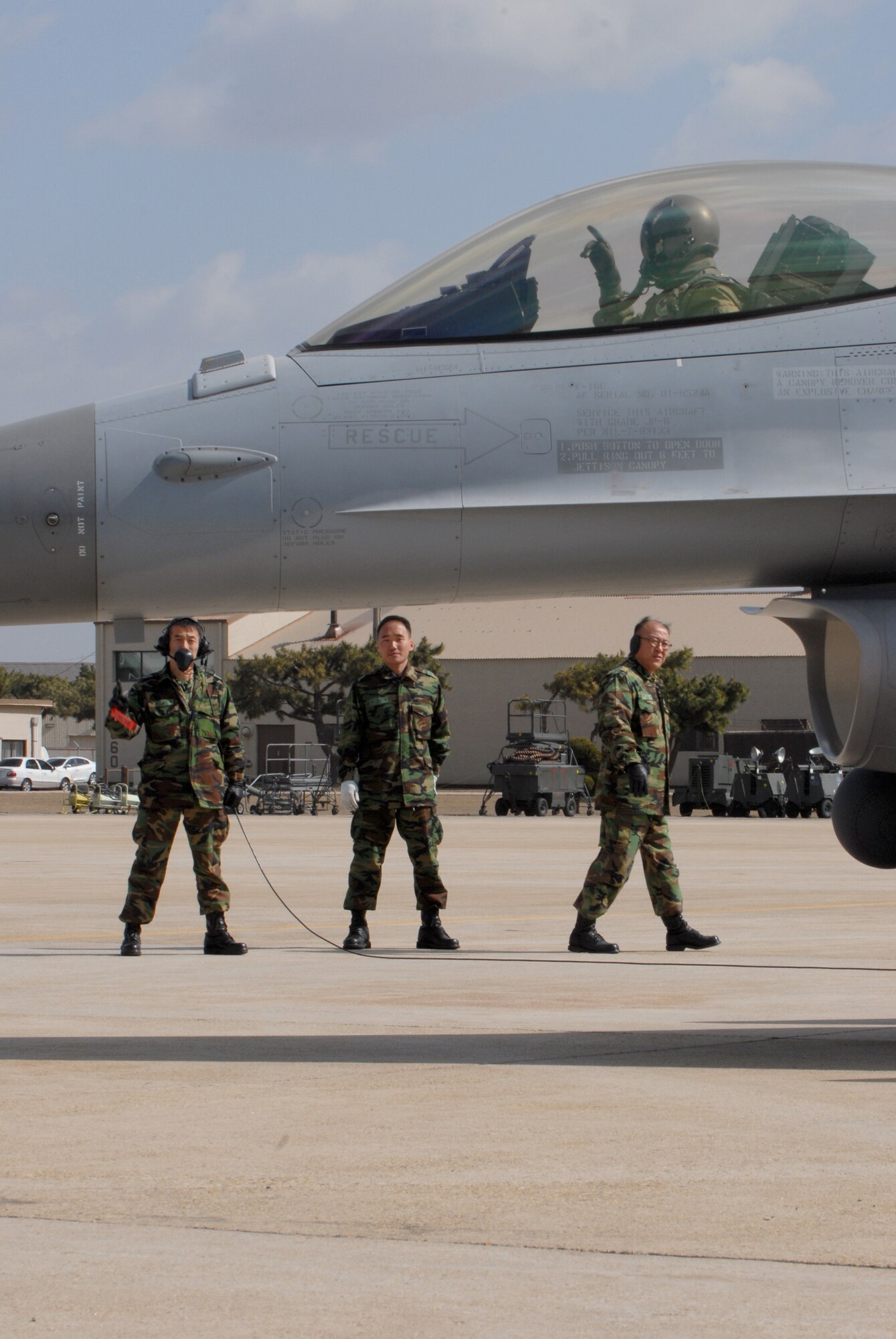 KUNSAN AIR BASE, Republic of Korea -- Republic of Korea Air Force crew chiefs perform one last preflight check during a Buddy Wing Exercise March 16. The exercise gives American and Korean pilots a chance to work together in case of possible joint combat actions. (U.S. Air Force photo/Senior Airman Roy Lynch)