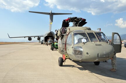 Joint Task Force- Bravo members load a C-17 Globemaster III March 20 with UH-60 Blackhawks and equipment before deploying March 21 from Soto Cano Air Base, Honduras to  Port au Prince, Haiti. Team Soto Cano sent more than 180,000 pounds of equipment and 40 personnel to support Joint Task Force-Haiti's disaster relief mission, Operation Unified Response. (U.S. Air Force photo/Staff Sgt. Bryan Franks) 