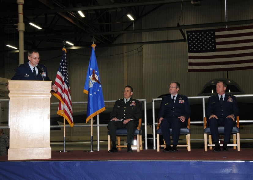 Col. Gregory Champagne, 131st Bomb Wing Commander, Missouri Air National Guard, addresses the wing and on stage officials during his assumption of command ceremony at Whiteman AFB, March 20.  Pictured L to R: Col. Gregory Champagne, Brig. Gen. Stephen Danner, Brig. Gen. Joh Owen, Brig. Gen. Stephen Cotter.   (U.S. Air Force photo by Master Sgt. Mary-Dale Amison  RELEASED)