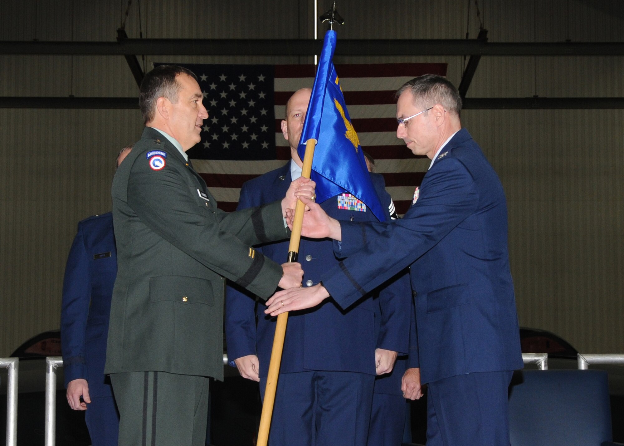 Col. Gregory Champagne, 131st Bomb Wing Commander, Missouri Air National Guard, accepts the 131st Bomb Wing guidon from Brig. Gen. Stephen Danner, adjutant general of the Missouri National Guard, during his assumption of command ceremony at Whiteman AFB, March 20.  (U.S. Air Force photo by Master Sgt. Mary-Dale Amison  RELEASED)