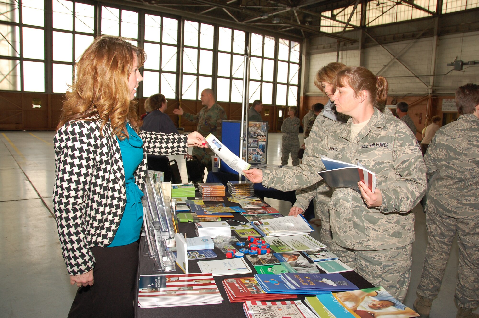 Tracy Anderson, a representative from Military OneSource, provides information to Master Sgt. Margie Rhives during Wingman Day in Hanger One at Lambert ANGB Mar. 20.  Military OneSource is known as a resource that provides help to all military members for deployment, relocation, and family issues.  (Photo by Staff Sgt. Amber Hodges)                                                                                                                                                                                                                                             