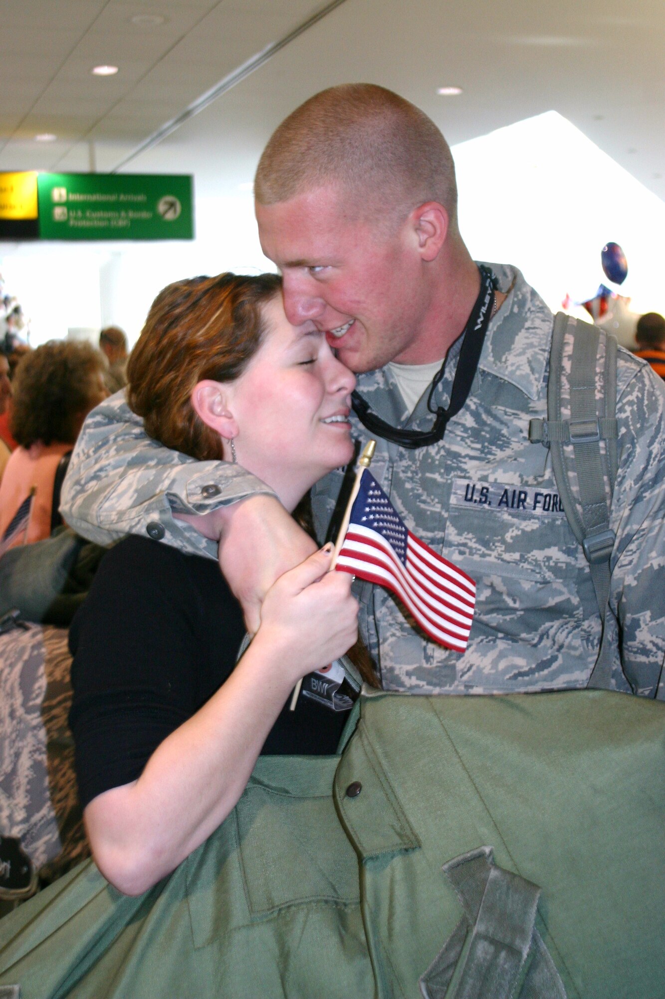 Senior Airman Jesse Terry an avionics technician with the 104th Fighter Squadron, Maryland Air National Guard, embraces his girlfriend, Amelia Young, at Baltimore Washington International Thurgood Marshall Airport March 20, 2010. Airman Terry and 147 other members of Maryland Air Guard were welcomed home from Afghanistan Saturday by Ms. Young and hundreds of other well wishers. His unit flew close air support combat sorties in Afganistan with the A-10C Thunderbolt II. (U.S. Air Force photo by Tech. Sgt. David Speicher/Released)