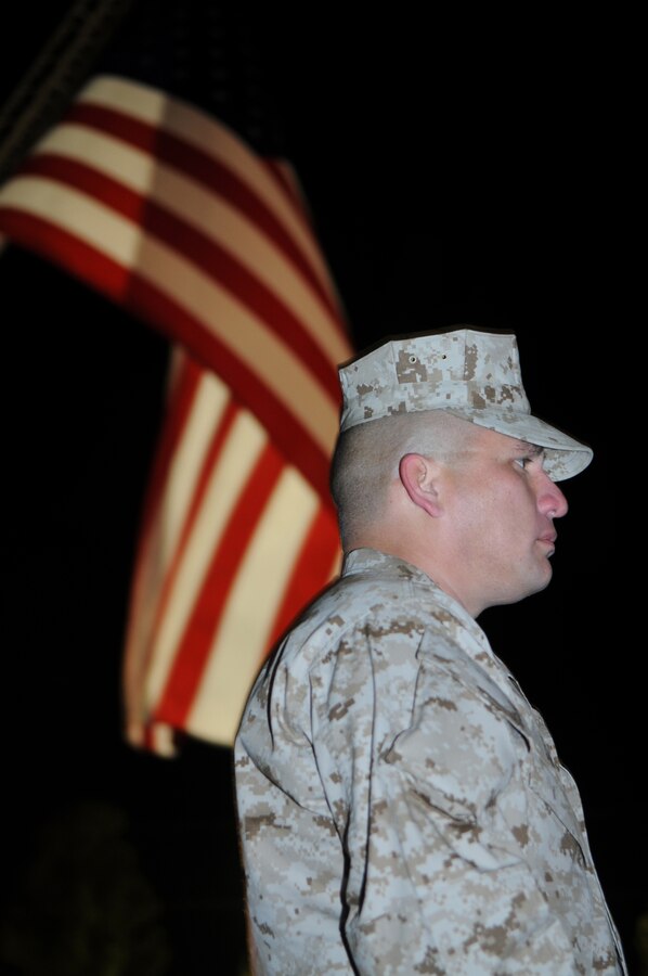 Gunnery Sgt. Fred Suniga waits for the opening ceremony of the 2010 Bataan Memorial Death March to commence at White Sands Missile Range, N.M., March 21, 2010. The annual 26.2-mile march is held in memory of the nearly 75,000 American and Filipino service members forced to march across 90 miles of the Philippine Bataan peninsula with limited rations and harsh heat while interned by the Japanese in 1942. The opening ceremony including a demonstration of White Sands' Color Guard, as well as an introduction of the Bataan survivors as dawn broke over the mountains. The Marines, along with a record-breaking number of 5,700 marchers, stepped off at 8 a.m.