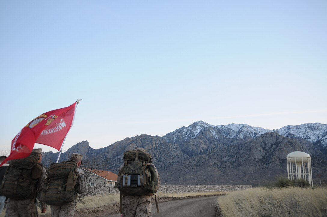 Yuma-based Marines Lance Cpl. Anthony Scott, left, Lance Cpl. Shane Fields and Gunnery Sgt. Fred Suniga march the last mile of the 2010 Bataan Memorial Death March at White Sands Missile Range, N.M., March 21, 2010. The annual 26.2-mile march is held in memory of the nearly 75,000 American and Filipino service members forced to march across 90 miles of the Philippine Bataan peninsula with limited rations and harsh heat while interned by the Japanese in 1942. For over 10 hours, the Marines endured debilitating weather, high altitudes and unforgiving terrain. Throughout the course, the Marines stopped for rest and medical treatment, but never quit. At least nine Marines from the Marine Corps Air Station in Yuma, Ariz., participated in the event.