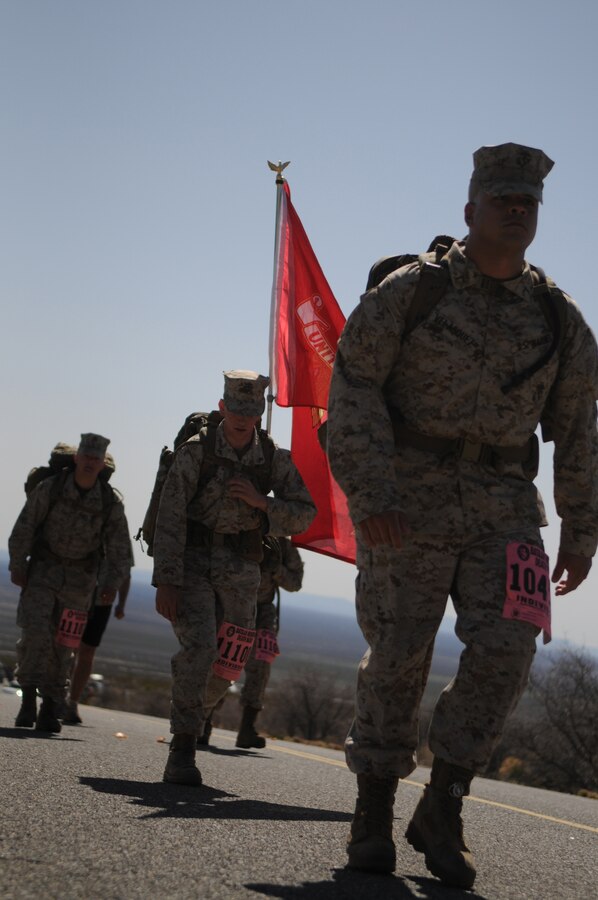 Yuma-based Marines Pfc. Adrian Velasquez, right, Lance Cpl. Shane Fields and Lance Cpl. Anthony Scott march up Mineral Hill during the 2010 Bataan Memorial Death March at White Sands Missile Range, N.M., March 21, 2010. The annual 26.2-mile march is held in memory of the nearly 75,000 American and Filipino service members forced to march across 90 miles of the Philippine Bataan peninsula with limited rations and harsh heat while interned by the Japanese in 1942. Mineral Hill, nine miles into the course, took the marchers more than a mile above sea level. "I don't think anyone can prepare themselves for this," said Scott. At least nine Marines from the Marine Corps Air Station in Yuma, Ariz., participated in the event.