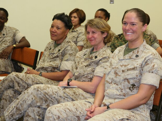 Master Gunnery Sgt. Sharon Garcia (far left), the shipping staff noncommissioned officer-in-charge with Combat Logistics Regiment 25, 2nd Marine Logistics Group; Sgt. Maj. Lisa Nilsson (middle), the 2nd Supply Battalion sergeant major; and Sgt. Kelley Bentley (right), a traffic management specialist with CLR-25, listen to a speech delivered by Lt. Col. Susan Seaman, the commanding officer of Headquarters and Support Battalion, Marine Corps Base Camp Lejeune, during a women’s appreciation service held in observance of Women’s History Month, aboard Camp Lejuene, N.C., March 22, 2010.  The three women pictured spoke at the service, sharing their experiences about being female Marines.