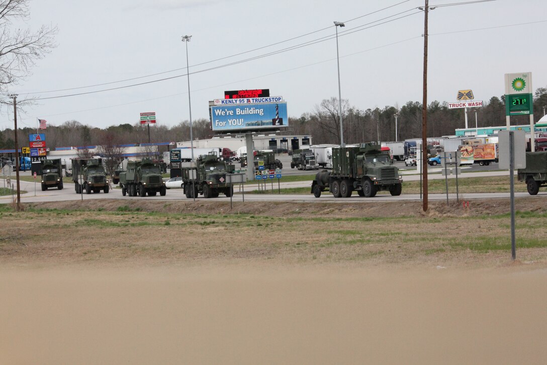 A convoy of Marines with the 26th Marine Expeditionary Unit drives through Kenly, NC, on it way to Fort Pickett, Va. to commence initial deployment training, March 22. The Fort Pickett training will be the first exercise for the MEU in the six-month pre-deployment training period culminating in its deployment this fall.