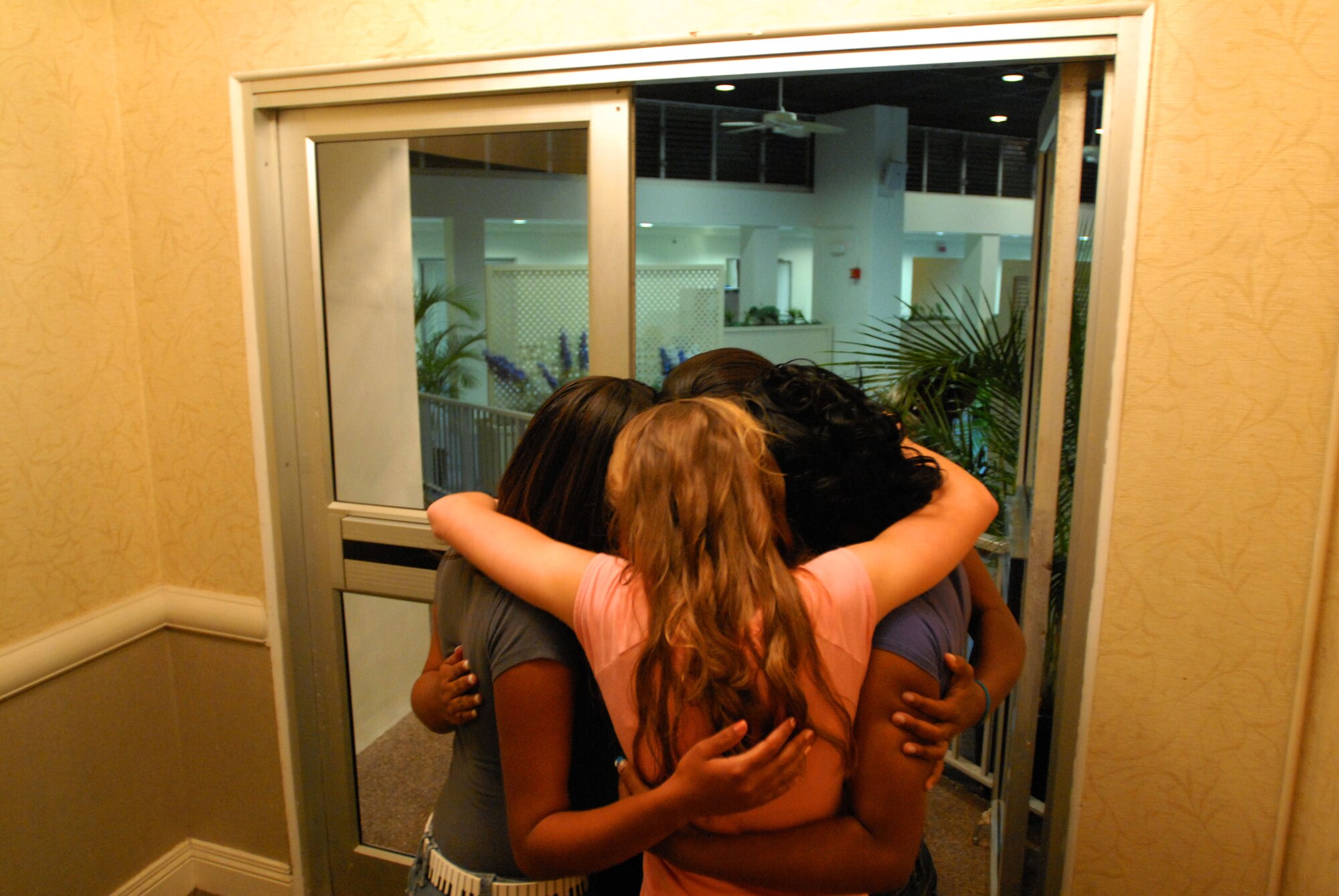 JOINT BASE PEARL HARBOR HICKAM, Hawaii – Teen beauty pageant contestants do one final group hug and prayer before performing during The Hickam Air Force Base Teen Scholarship Pageant here, March 20. The pageant was presented by the Women’s History Month Committee and was able to acquire scholarships for all participants. (U.S. Air Force photo/Senior Airman Gustavo Gonzalez)