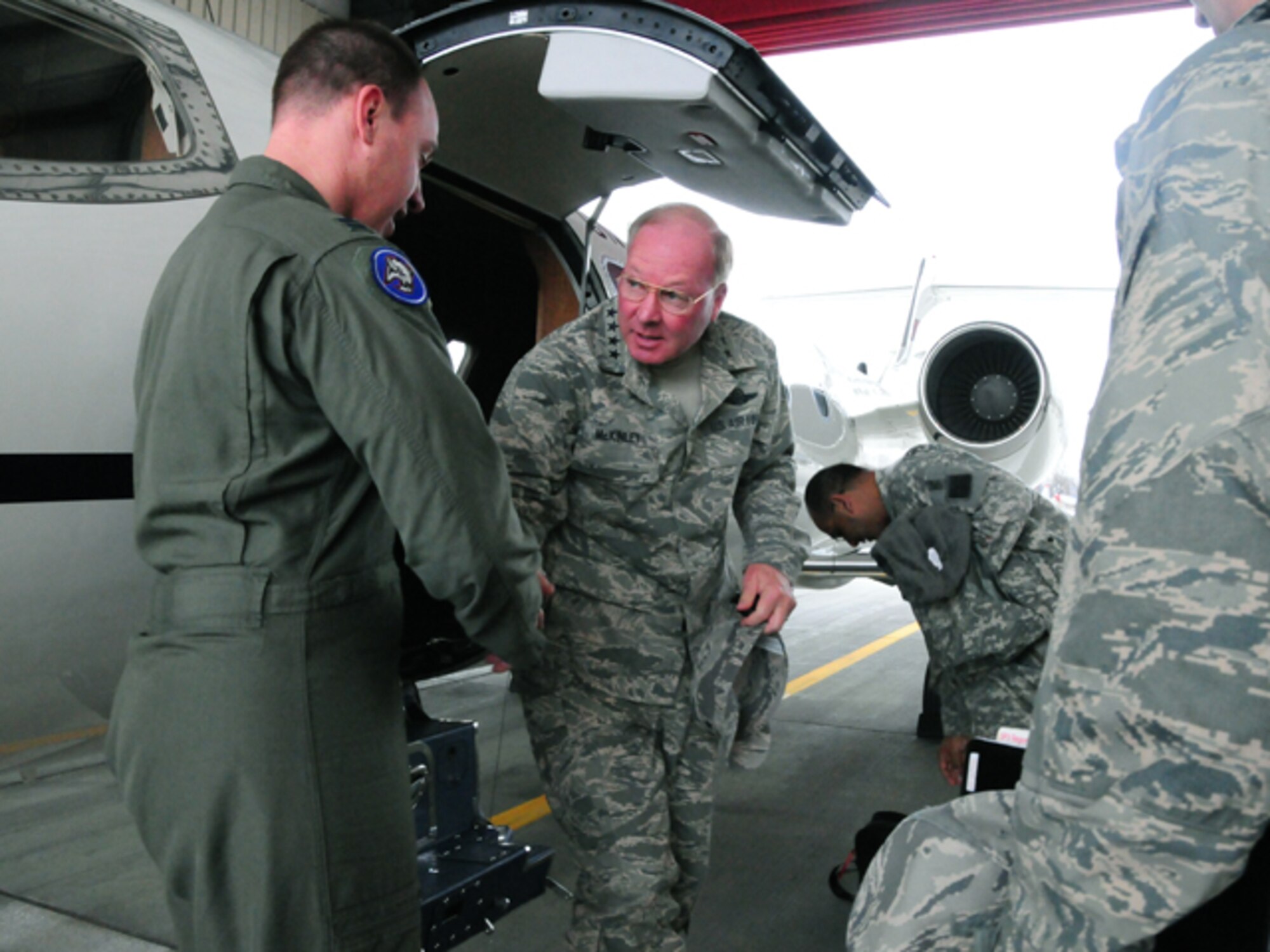 Gen. Craig R. McKinley, chief of the National Guard Bureau, shakes hands Capt. Christopher Domitrovich, 119th Wing C-21 pilot, as he arrives at the North Dakota Air National Guard for a day long visit of the flood efforts taking place in the state on March 22.  During his visit, McKinley received an update from the Emergency Operations Center, an aerial reconnaissance of the Red River area and a ground tour of the city where he made frequent stops to visit with the North Dakota Guard members on duty.