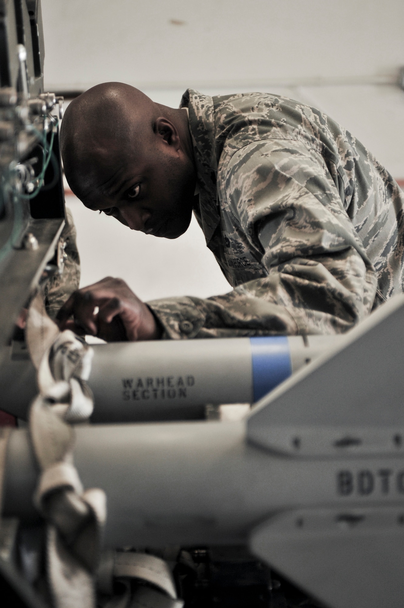 ELMENDORF AIR FORCE BASE, Alaska – Lt. Col. Kenyon Bell, 3rd Equipment Maintenance Squadron commander, leans in to get a better look at one of his munitions flights’ missiles March 19. Colonel Bell was named the winner of the 2009 Lt. Gen. Leo Marquez Missile and Munitions Maintenance Field Grade Manager award. The colonel is expected to accept his award in Washington D.C. April 28. (Air Force photo by Airman 1st Class Christopher Gross)
