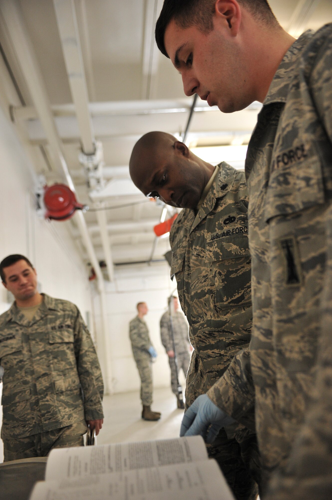 ELMENDORF AIR FORCE BASE, Alaska – Lt. Col. Kenyon Bell, 3rd Equipment Maintenance Squadron commander, listens as Senior Airman Edward Reagle, 3rd EMS Munitions Flight, goes over the missile maintenance plans March 19. Colonel Bell was named the winner of the 2009 Lt. Gen. Leo Marquez Missile and Munitions Maintenance Field Grade Manager award. The colonel is expected to accept his award in Washington D.C. April 28. (Air Force photo by Airman 1st Class Christopher Gross)