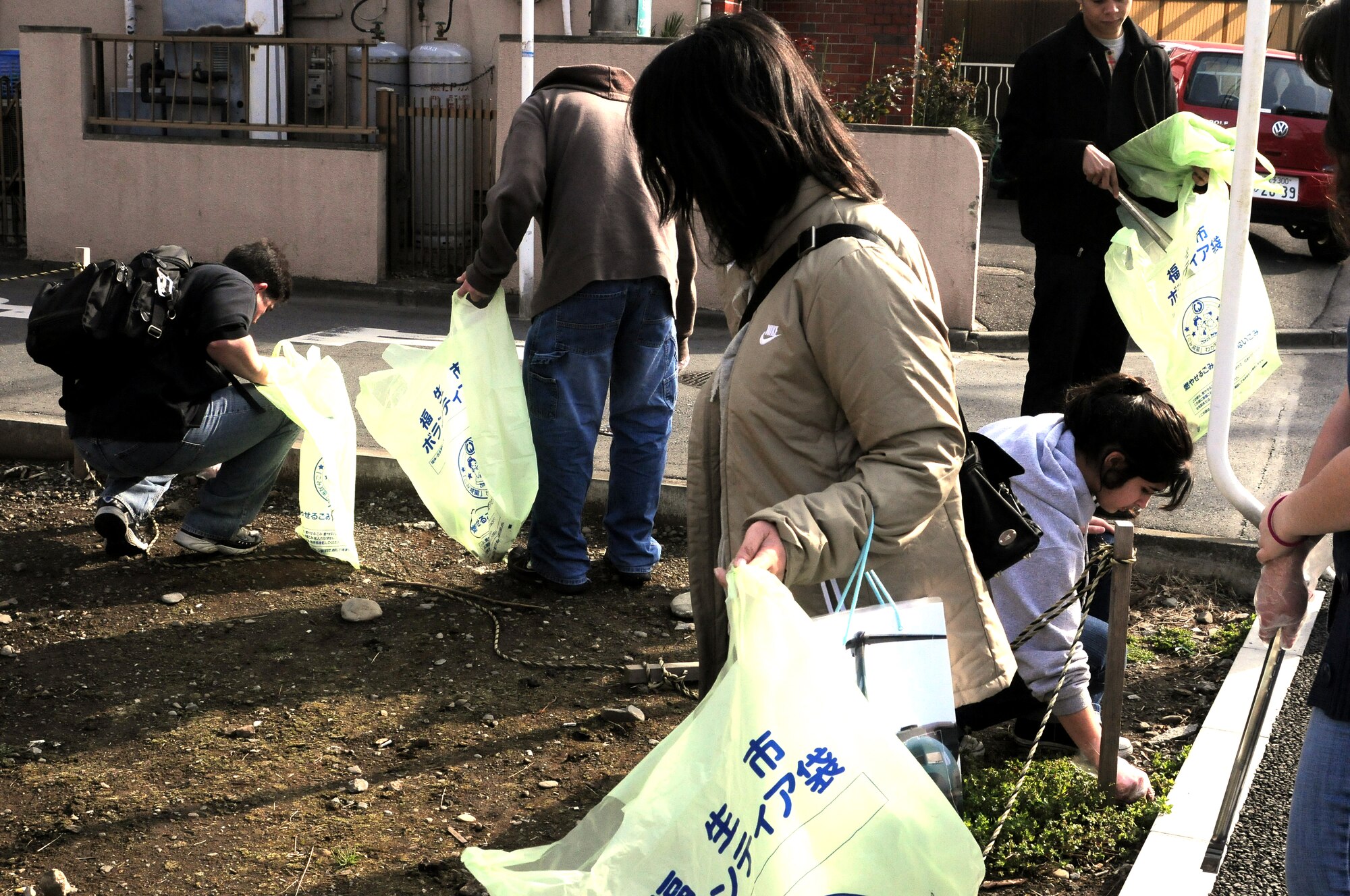 FUSSA, Japan -- Volunteers pick up trash as part of the Great American Trash Bash March 20. The "Trash Bash" was held as a way for the residents of Yokota to give back to the Fussa Community. (U.S. Air Force photo/Airman 1st Class Katrina Menchaca)