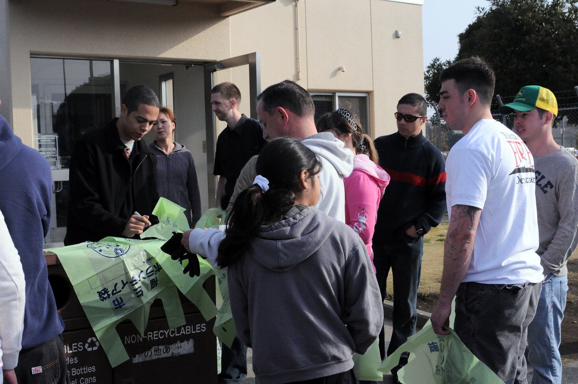 FUSSA, Japan -- Volunteers receive bags outside the Visitor's Center for the Great American Trash Bash March 20. The trash bash was held as a way for the residents of Yokota to give back to the Fussa Community. (U.S. Air Force photo/Airman 1st Class Katrina Menchaca) 