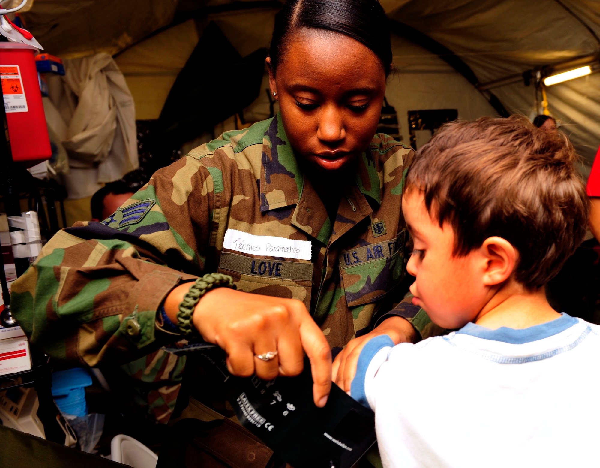 Senior Airman Kahliha Love checks the vital signs of a Chilean child at the expeditionary hospital March 20, 2010, in Angol, Chile. About 60 medical Airmen are working alongside local Chilean medics to provide support to meet the daily medical needs of the 110,000 people in the region. The local hospital in Angol was deemed structurally unsound after an 8.8-magnitude earthquake Feb. 27, 2010. Airman Love is an aerospace medical technician assigned to the 81st Medical Operating Squadron at Keesler Air Force Base, Miss. (U.S. Air Force photo/Senior Airman Tiffany Trojca)
