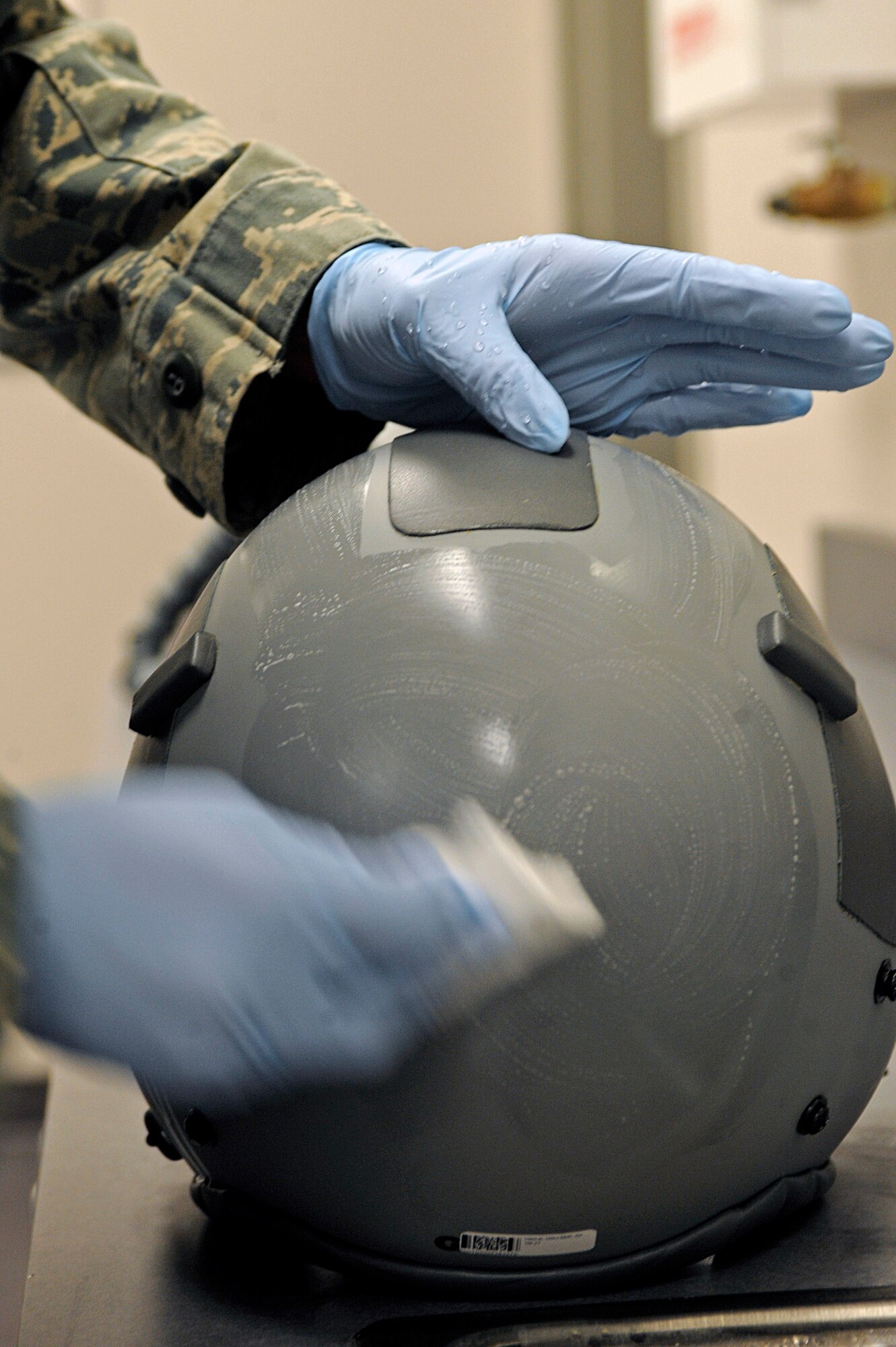 ELLSWORTH AIR FORCE BASE, S.D. -- Senior Airman Jennifer Lopez, 37th Bomb Squadron aircrew equipment technician, polishes a flight helmet during a routine inspection, March 22. Airman Lopez also inspects harnesses, vests and chemical bags for defects as part of her daily duties. (U.S. Air Force photo/Airman 1st Class Matthew Flynn)