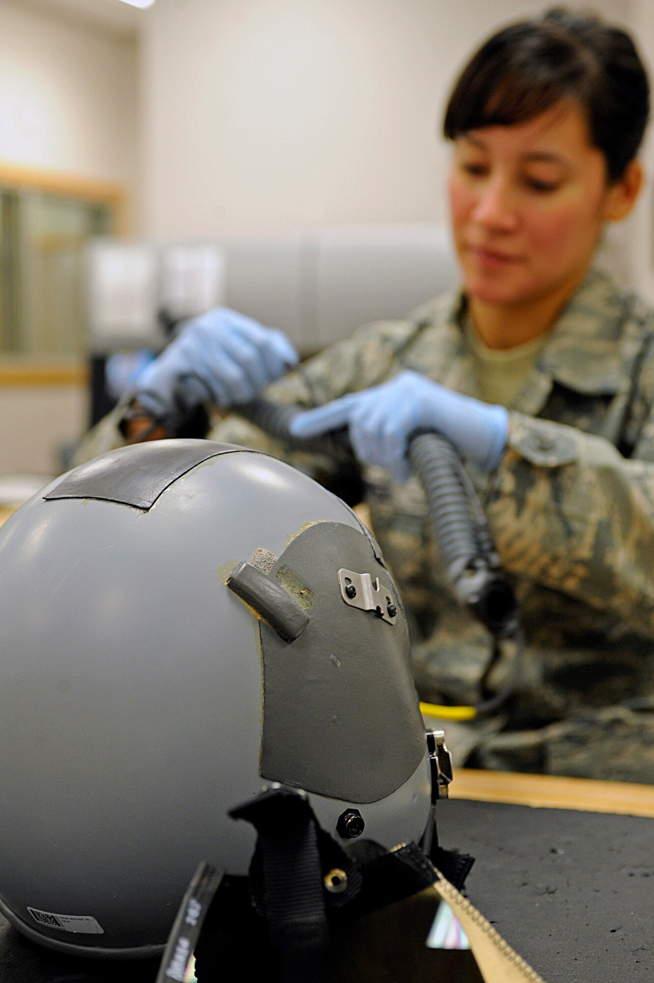 ELLSWORTH AIR FORCE BASE, S.D. -- Senior Airman Jennifer Lopez, 37th Bomb Squadron aircrew flight equipment technician, picks out a tool while inspecting flight helmets, March 22. Airman Lopez is one of several women assigned to the aircrew equipment shop. Since 1987, the month of March has been recognized as Women's History Month and highlights the accomplishments of women, both past and present. (U.S. Air Force photo/Airman 1st Class Matthew Flynn)