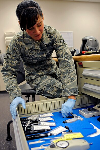 ELLSWORTH AIR FORCE BASE, S.D. -- Senior Airman Jennifer Lopez, 37th Bomb Squadron aircrew flight equipment technician, picks out a tool while inspecting flight helmets, March 22. Aircrew flight equipment personnel inspect all aircrew equipment and survival gear before it is used. (U.S. Air Force photo/Airman 1st Class Matthew Flynn)
