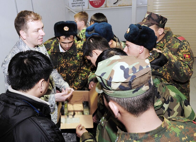 Tech. Sgt. Michael Yates compares a simulated improvised explosive device to its X-ray with Kyrgyz army explosive ordnance disposal technicians during a subject matter information exchange March 16, 2010, at the Transit Center at Manas, Kyrgyzstan. Sergeant Yates is the 376th Expeditionary Civil Engineer Squadron EOD Flight chief. (U.S. Air Force photo/Staff Sgt. Carolyn Viss)
