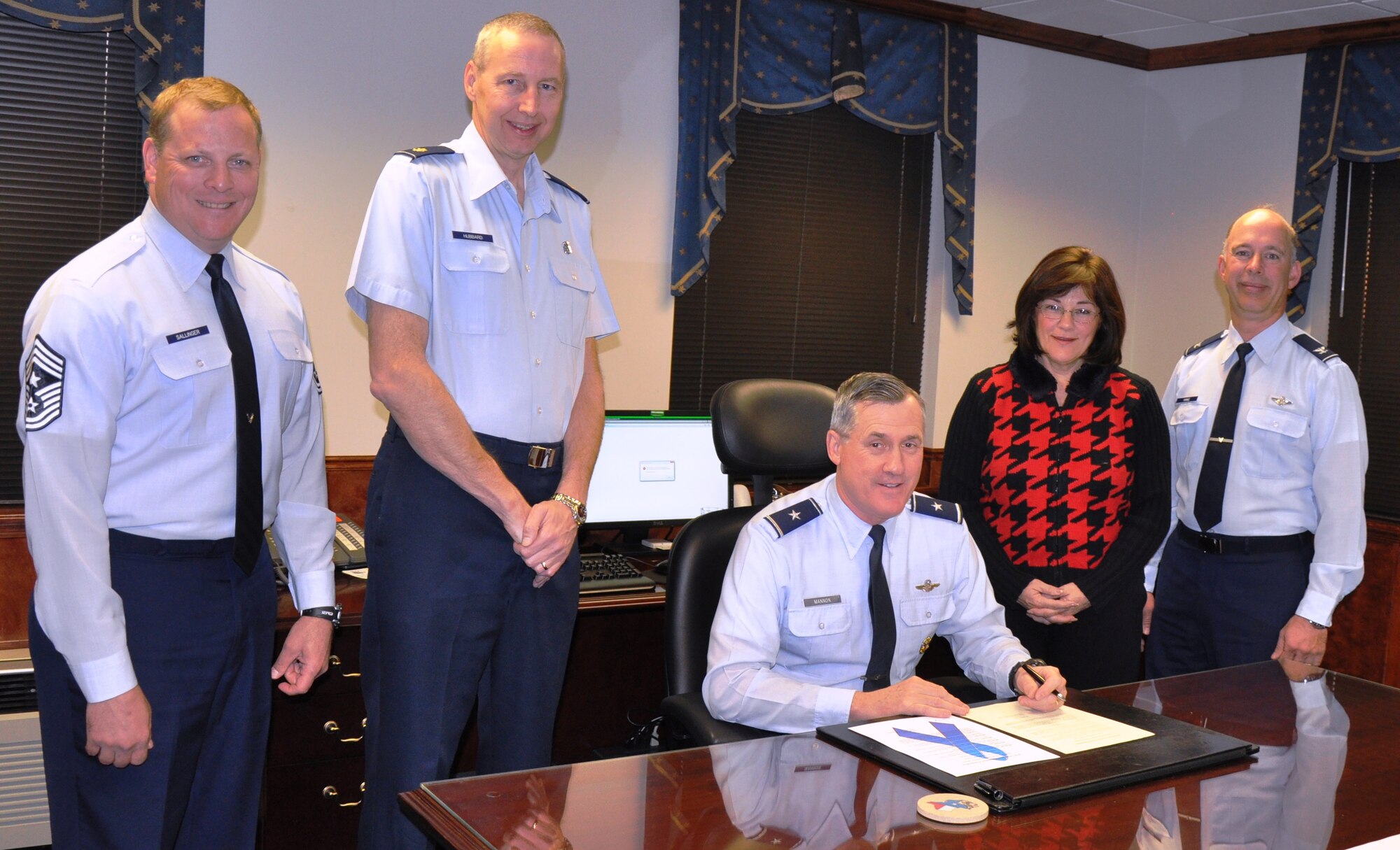 Brig. Gen. O.G. Mannon (center), 82nd Training Wing commander, signs a proclamation declaring April as Sheppard's official Sexual Assault Awareness Month and Child Abuse Prevention Month March 22. Pictured from left to right are Chief Master Sgt. Kenneth Sallinger, 82nd TRW command chief; Maj. William Hubbard, 82nd Medical Operations Squadron; General Mannon; Valerie Cook, 82nd TRW Sexual Assault Response Coordinator Office chief; and Col. Michael Hake, 82nd TRW vice commander. (U.S. Air Force photo/Airman 1st Class Valerie Hosea)