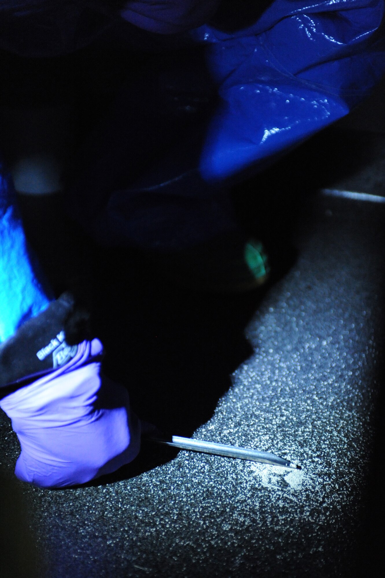 WHITEMAN AIR FORCE BASE, Mo. -Senior Airman Hellen Cremer, 509th Medical Operations Squadron bio-environmental engineer, samples a suspicious powder found on the floor during a biological chemical challenge, here, March 16, 2010.  The challenge gauged Team Whiteman's ability to deal with terrorist threats while deployed and in garrison.  (U.S. Air Force photo by Airman 1st Class Carlin Leslie) (Released)




