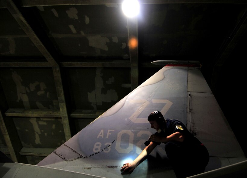 Airman 1st Class David Eckert, 18th Aircraft Maintenance Squadron technical aviation mechanic, conducts his pre-flight checks on an F-15C Eagle during Beverly High 10-02 at Kadena Air Base, Japan, March 23.  The 18th Wing is participating in a Local Operational Readiness Exercise March 22-26 to test the readiness of Kadena Airmen. (U.S. Air Force photo/Tech. Sgt. Rey Ramon)  