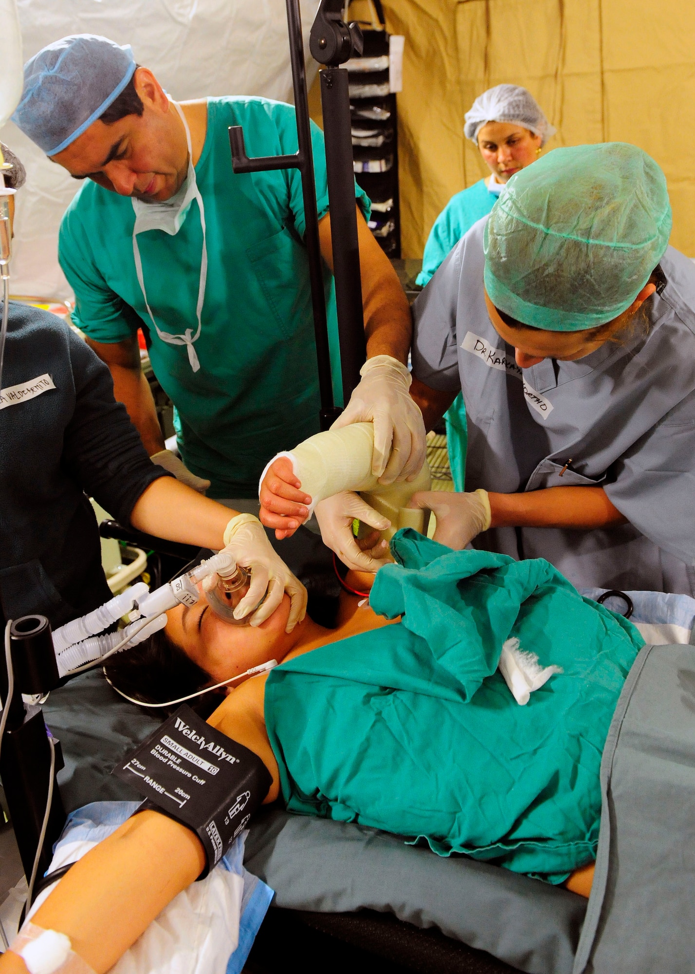 A Chilean surgeon (left) and Maj. Yekaterina Karpitskaya (right) work side-by-side to cast a Chilean child?s broken arm at the expeditionary hospital March 19, 2010, in Angol, Chile. While the local hospital in Angol is being rebuilt, this medical facility will provide much needed space to provide medical care for the local community. The hospital includes several tents for care, including an emergency room and two operating rooms. Major Karpitskaya is an orthopedic surgeon assigned to the 81st Medical Surgical Squadron at Keesler Air Force Base, Miss. (U.S. Air Force photo/Senior Airman Tiffany Trojca)
