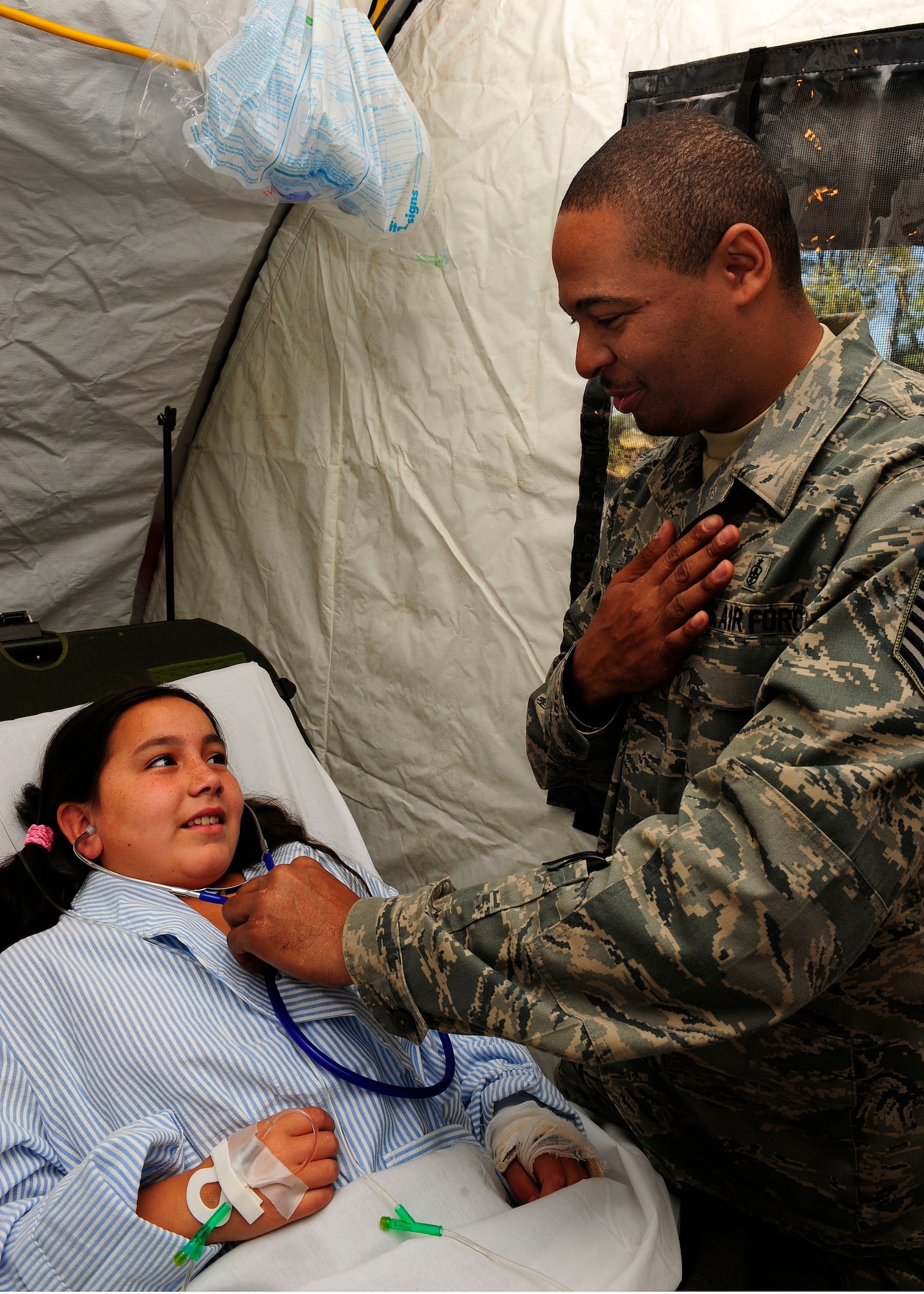 Tech. Sgt. Donelle Clark explains how a stethoscope works to a Chilean child at the expeditionary hospital March 19, 2010, in Angol, Chile. About 60 medical Airmen are working alongside local Chilean medics to provide support to meet the daily medical needs of the local community in the mobile facility. The EMEDS team is equipped and staffed to provide surgical, primary care, pediatric, radiological, gynecological, laboratory and pharmaceutical services. Sergeant Clark is an aerospace medical technician assigned to the 81st Medical Surgical Squadron at Keesler Air Force Base, Miss. (U.S. Air Force photo/Senior Airman Tiffany Trojca)
