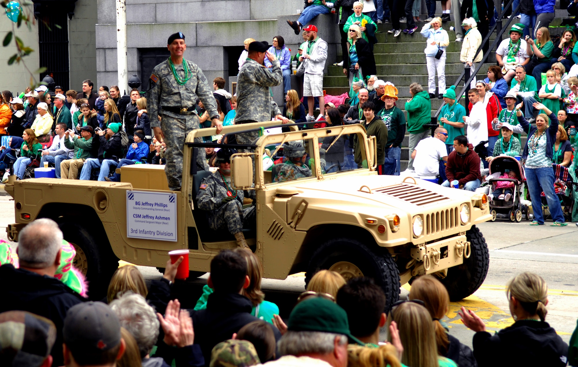 SAVANNAH, Ga. -- Army Brig. Gen. Jeffery Phillips, deputy commanding general of the Third Infantry Division, and Command Sgt. Maj. Jeffery Ashmen, command sergeant major of the 3rd Infantry Division, stand in the back of a high-mobility, multipurpose wheeled vehicle greeting the crowd at the Savannah, Ga., St. Patrick's day parade. Savannah hosts the second largest St. Patrick's Day parade in the nation. Shaw Air Force Base outdoor recreation took members from Team Shaw to the St. Patrick's Day parade. (U.S. Air Force photo/Airman 1st Class Daniel Phelps)