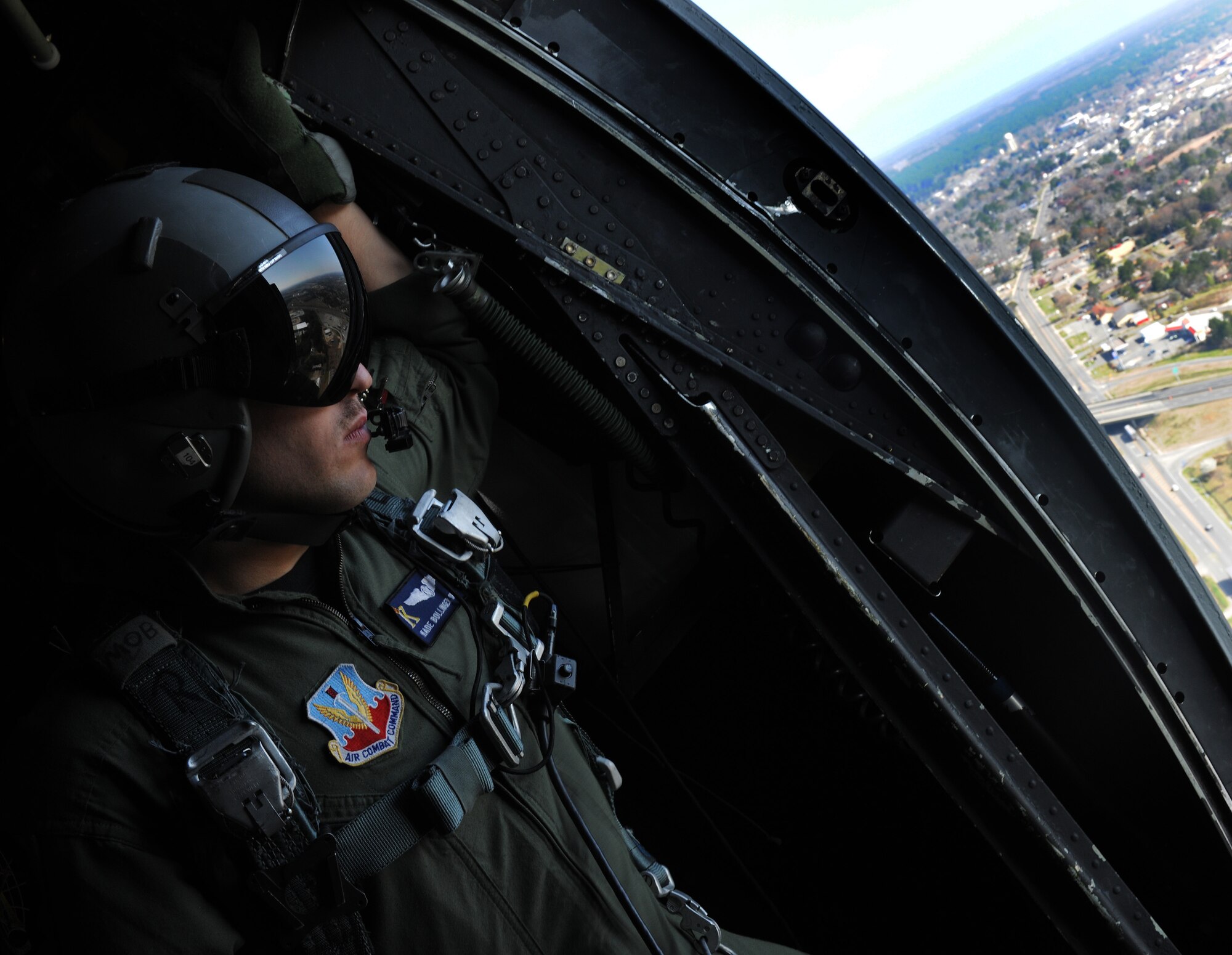 MOODY AIR FORCE BASE, Ga. -- Senior Airman Kade Bollinger, 71st Rescue Squadron HC-130P/N Combat King loadmaster, checks the engine pods  while looking out the paratroop doors during a flight training session here March 16. The Combat King is used for many things including personnel recovery and air drops, as well as humanitarian and combat missions. (U.S. Air Force photo by Airman 1st Class Benjamin Wiseman/Released)