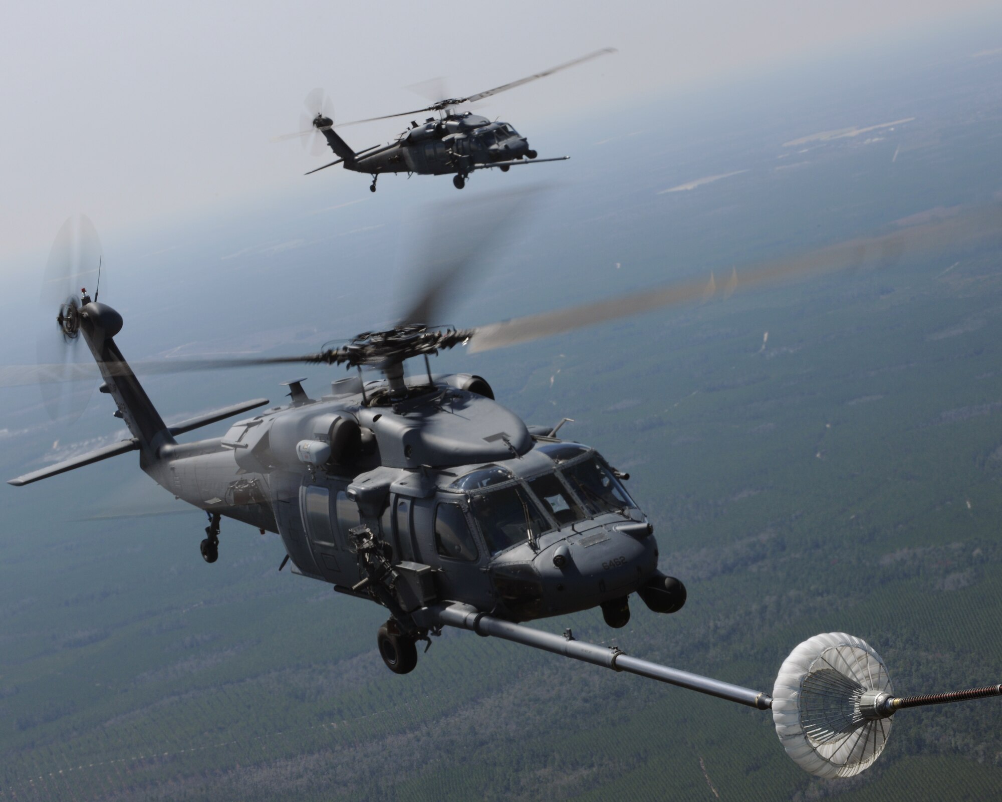 MOODY AIR FORCE BASE, Ga. -- An HH-60G Pave Hawk from the 41st Rescue Squadron prepares to refuel while in-flight as another HH-60G remains in an observation position here March 16. Both were refueled by a HC-130P/N Combat King from the 71st Rescue Squadron during a flight training session. The Combat King is capable of traveling up to 4,000 miles and carrying up to 73,000 pounds of fuel. (U.S. Air Force photo by Airman 1st Class Benjamin Wiseman/Released)