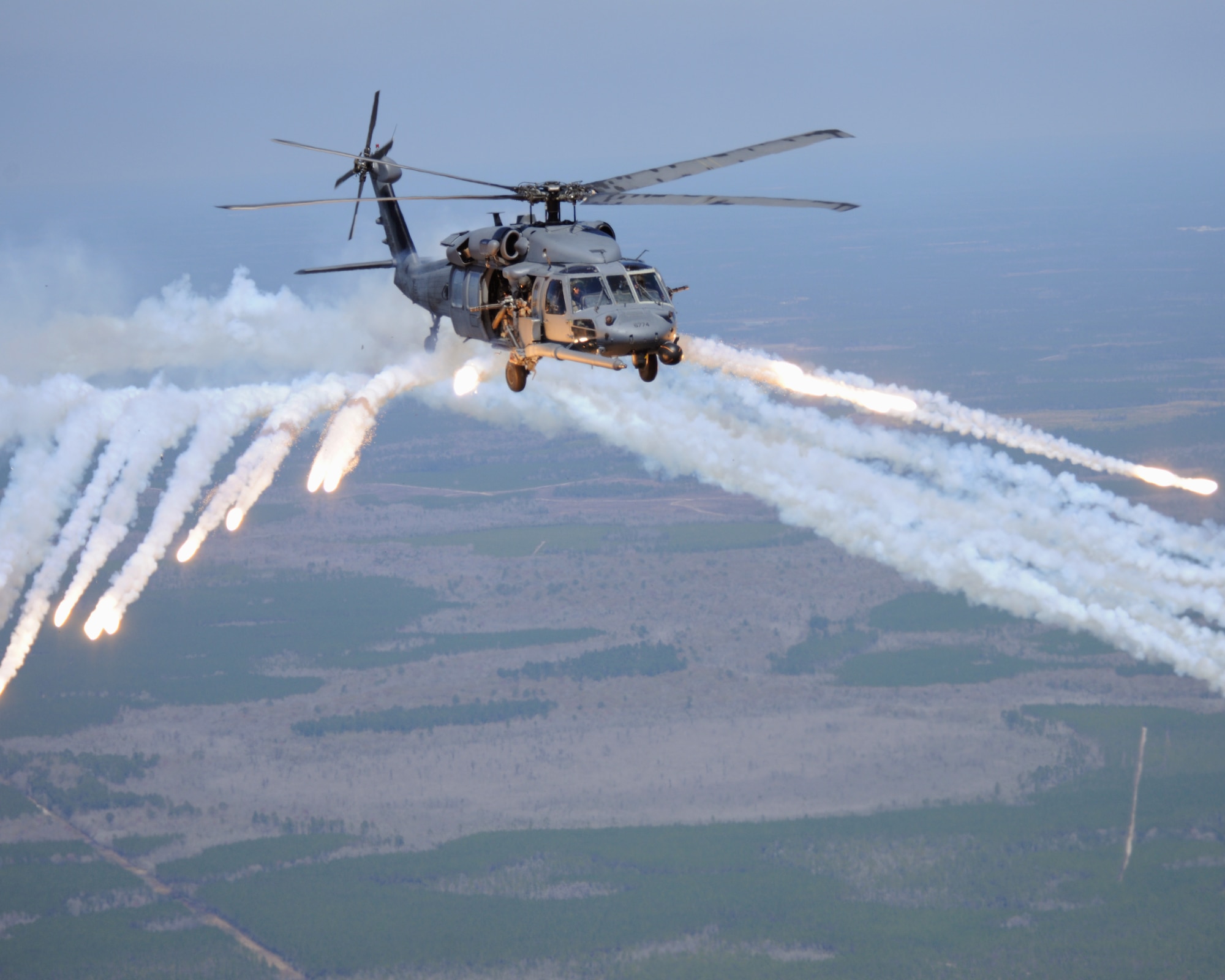 MOODY AIR FORCE BASE, Ga. -- An HH-60G Pave Hawk from the 41st Rescue Squadron empties its remaining flares during an in-flight refueling training session here March 16. Refueling allows the aircraft to travel further in combat situations, allowing essential personnel and equipment to be delivered where needed. (U.S. Air Force photo by Airman 1st Class Benjamin Wiseman/Released)