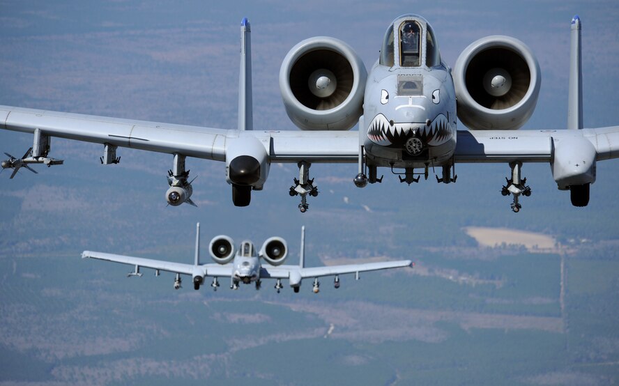 MOODY AIR FORCE BASE, Ga. -- Two A-10C Thunderbolt II aircraft from the 74th and 75th Fighter Squadrons fly behind a HC-130P/N Combat King from the 71st Rescue Squadron during a flight training session here March 16. The A-10C is the first Air Force aircraft specially designed for close air support of ground forces. (U.S. Air Force photo by Airman 1st Class Benjamin Wiseman/Released)