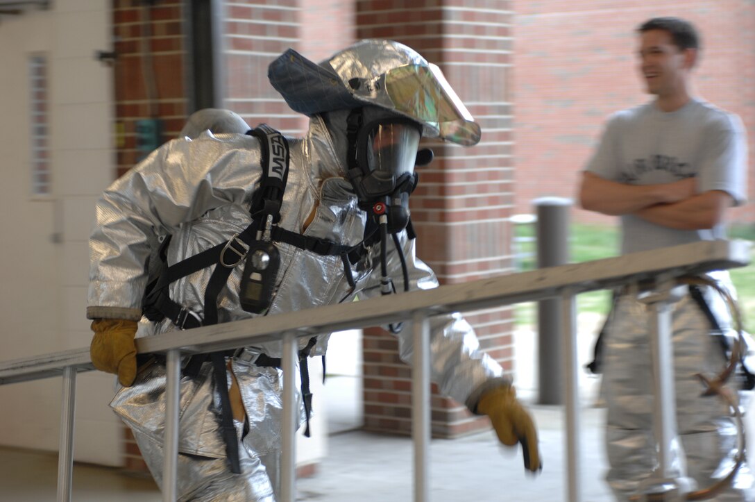 LANGLEY AIR FORCE BASE, Va. – Col. Matt Molloy, 1st Fighter Wing commander, carries a ladder as part of a firefighter combat challenge test March 22.  The combat challenge test is an annual requirement for Langley firefighters. (U.S. Air Force photo/Tech. Sgt. April Wickes)