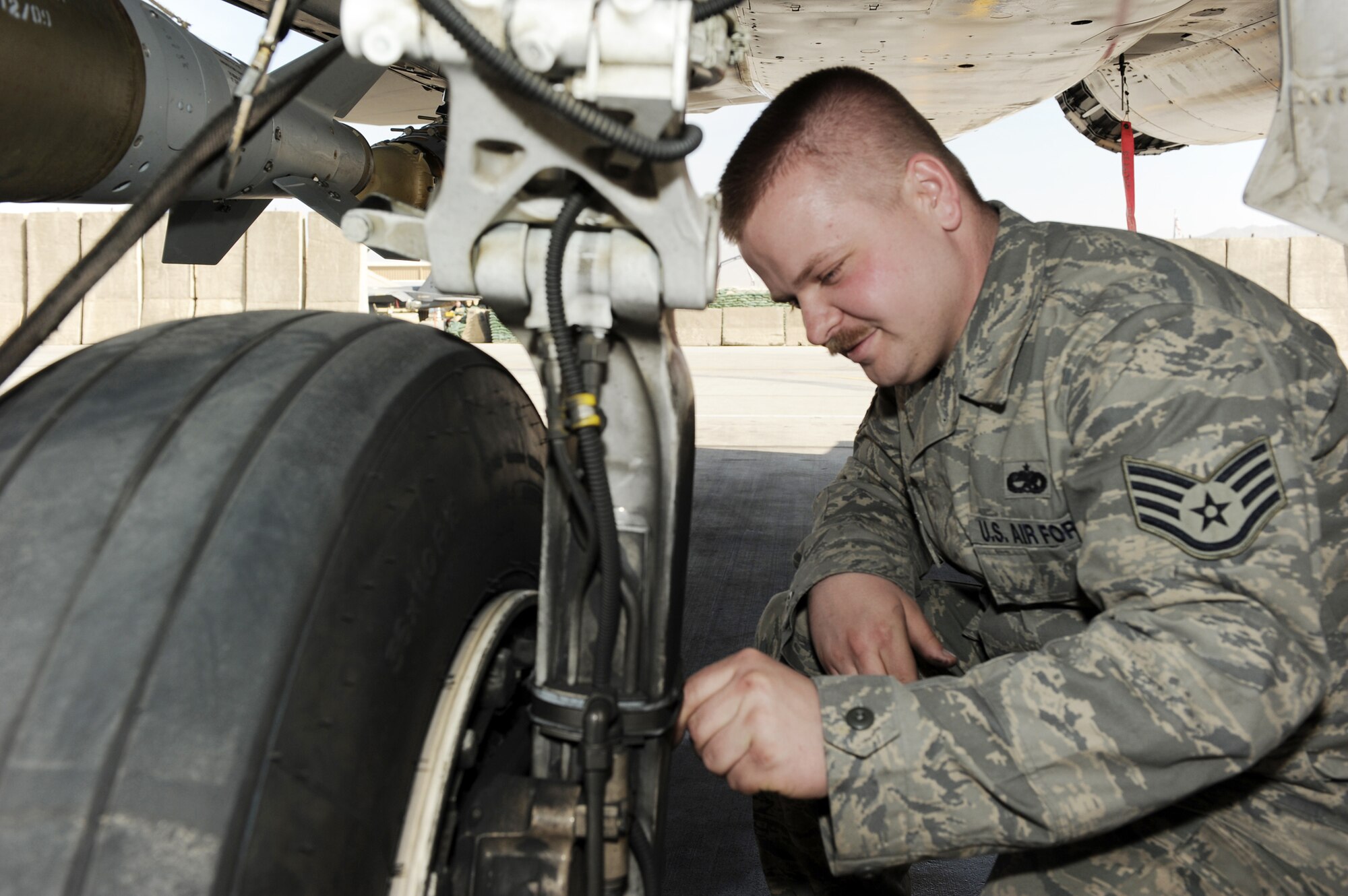 Staff Sgt. Justin Wilson performs a brake inspection on an F-15E Strike Eagle during an aircraft inspection March 16, 2010, at Bagram Airfield, Afghanistan. Sergeant Wilson is a 494th Aircraft Maintenance Unit crew chief deployed from Royal Air Force Lakenheath, England, and is a native of Malone, N.Y. (U.S. Air Force photo/Staff Sgt. Richard Williams)