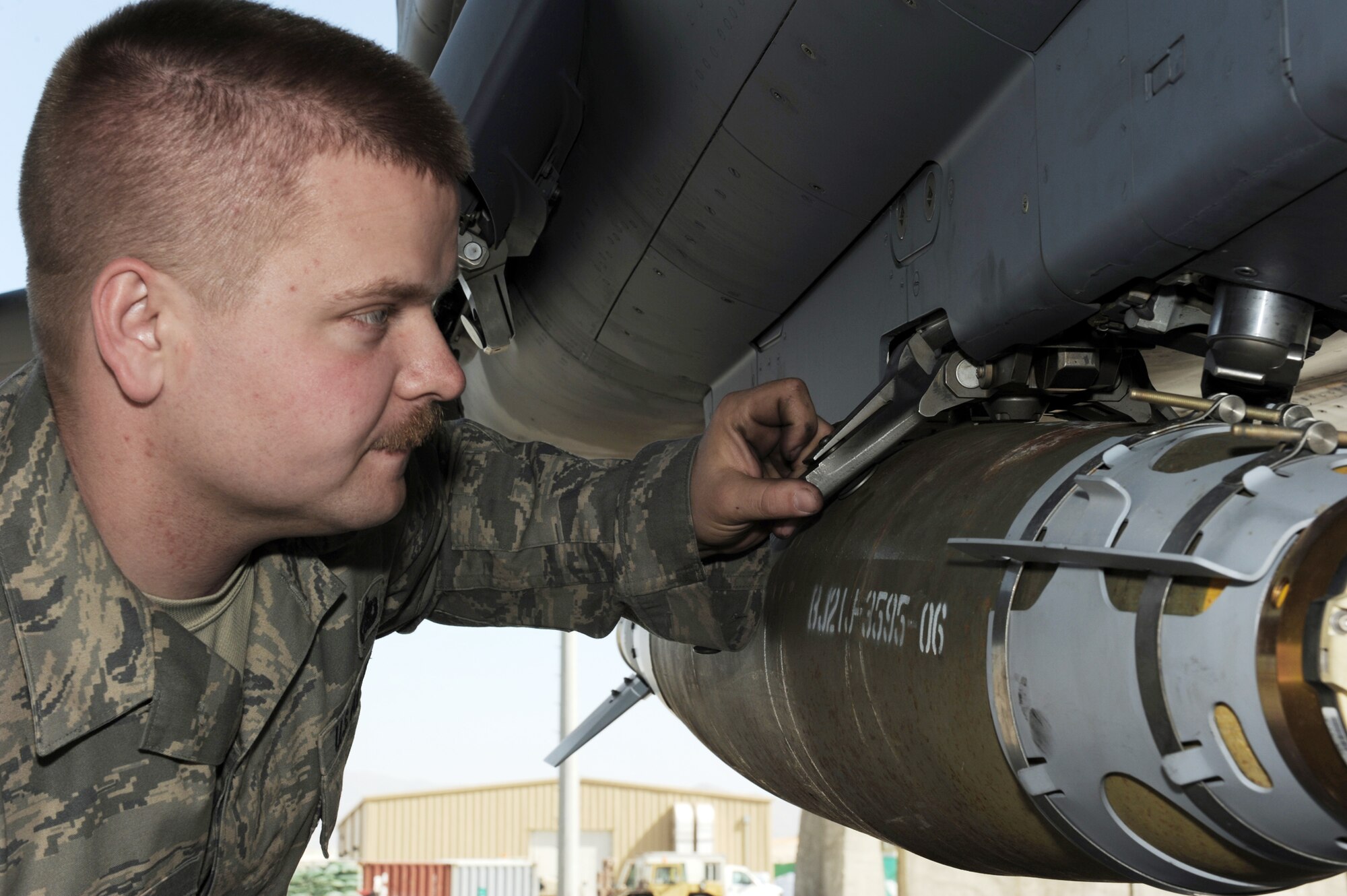 Staff Sgt. Justin Wilson inspects the bomb rack of an F-15E Strike Eagle during a preflight aircraft inspection March 16, 2010, at Bagram Airfield, Afghanistan. Sergeant Wilson is a 494th Aircraft Maintenance Unit crew chief deployed from Royal Air Force Lakenheath, England, and is a native of Malone, N.Y. (U.S. Air Force photo/Staff Sgt. Richard Williams)