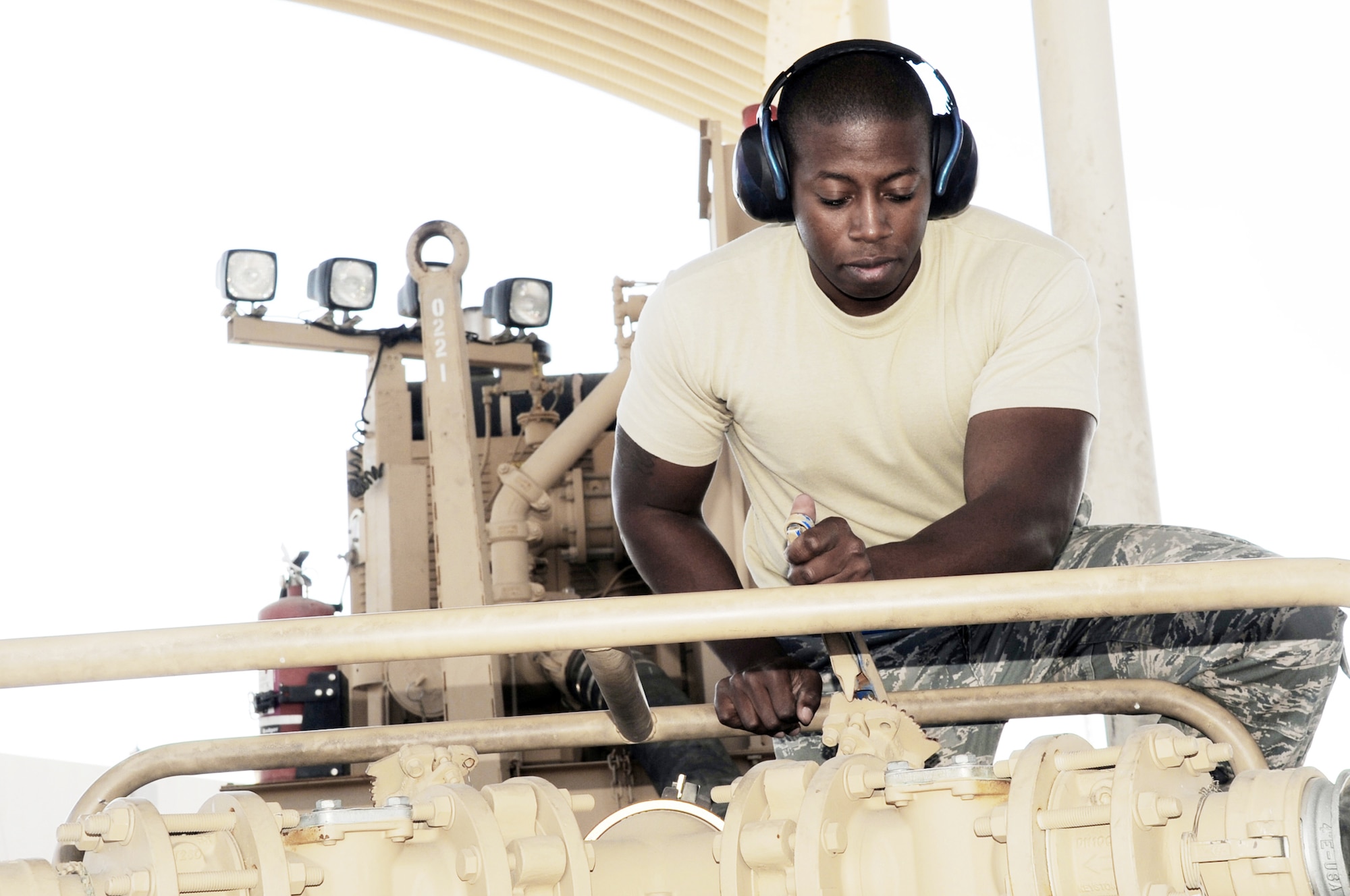 Senior Airman Brandon Bailey adjusts an R-18 fuel pump during operations at the fuel off-load facility for the 380th Air Expeditionary Wing Jan. 6, 2010, at a base in Southwest Asia. (U.S. Air Force photo/Master Sgt. Scott T. Sturkol)