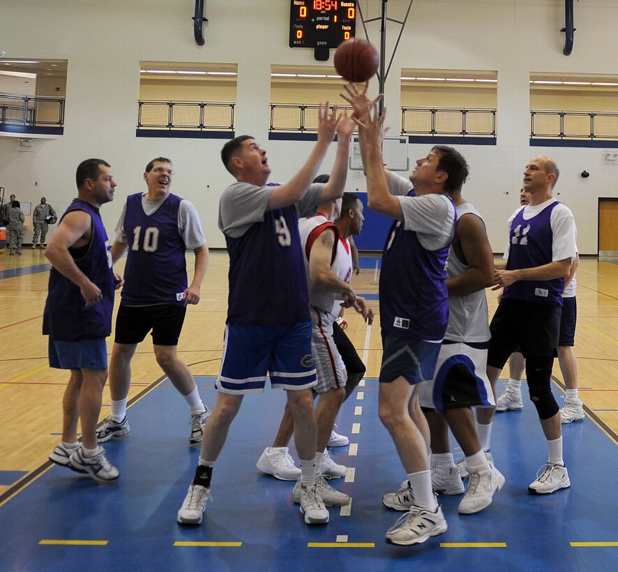 LANGLEY AIR FORCE BASE, Va. – Col. Donald Kirkland, 633d Air Base Wing commander, helps his teammates score in the Chiefs versus Eagles March Madness game at the Shellbank Fitness Center March 19. This is the first year the two ranks have competed against each other here at Langley; Chiefs won, 50-38. (U.S. Air Force photo/Airman Rebecca Montez)