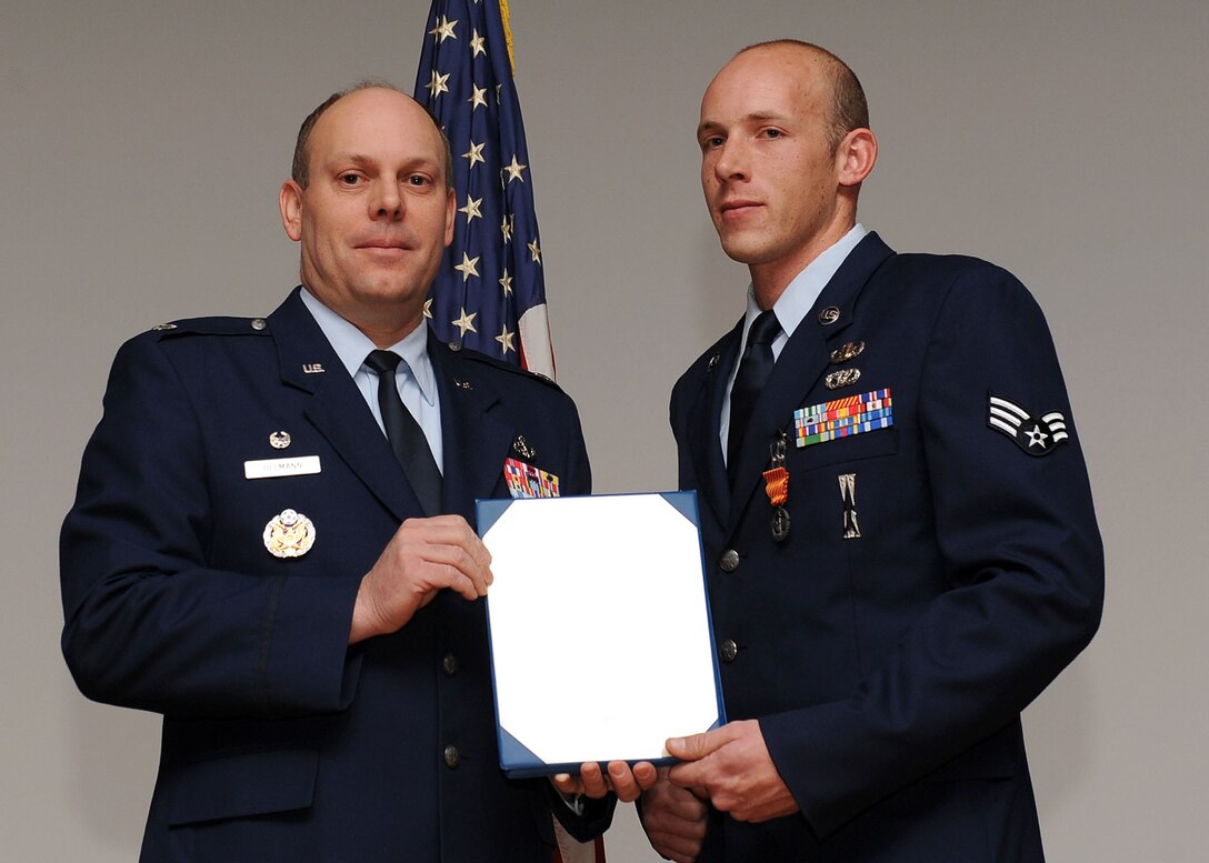 LANGLEY AIR FORCE BASE, Va. -- Senior Airman Bradford Bends, 633 Civil Engineer Squadron Explosive Ordnance Disposal team, is awarded the Air Force Combat Action Medal here March 19. (U.S. Air Force photo/Airman Rebecca Montez)