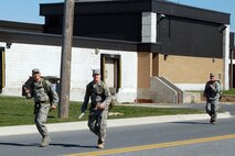 Staff Sgt. Herbert Dungca (from left) and Senior Airman Jonathan Howard, Air Force Mortuary Affairs Operations Center Dignified Transfer team members set the pace as Capt. Gordon Swain, Dignified Transfer officer in charge, brings up the rear during the 436th Security Forces Squadron's 11th Annual Ruck March held March 20. The annual 6.2 mile march is a fundraiser to honor the veterans of the Korean War who fought in the Battle of the Chosin Reservoir. This battle was fought between Army Lt. Gen. Edward M. "Ned" Almond's X Corps, comprised of approximately 20,000 Army and Marine Troops, against 120,000 Chinese troops. "About seven of us participated in the march for camaraderie, fitness and to give back to the veterans in commemoration of what they did in Korea," said Staff Sgt. Herbert Dungca, AFMAO Dignified Transfer member. "It was a perfect day, but it was definitely a challenge walking six miles with a 30-pound load. We didn't win but everyone finished and had fun." (U.S. Air Force photo/Master Sgt. Robert Snyder)