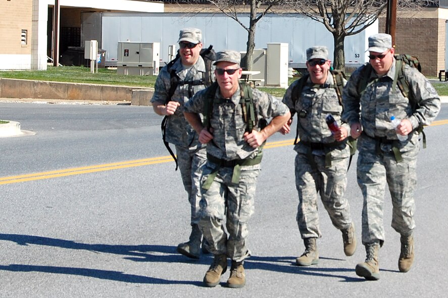 Chief Master Sgt. David Fish (far left), Air Force Mortuary Affairs Operations Center enlisted manager, and Senior Master Sgt. James Segler (far right), AFMAO superintendent, join other senior NCO's during the 436th Security Forces Squadron's 11th Annual Ruck March held March 20. The annual 6.2 mile march is a fundraiser to honor the veterans of the Korean War who fought in the Battle of the Chosin Reservoir. This battle was fought between Army Lt. Gen. Edward M. "Ned" Almond's X Corps, comprised of approximately 20,000 Army and Marine Troops, against 120,000 Chinese troops. "About seven of us participated in the march for camaraderie, fitness and to give back to the veterans in commemoration of what they did in Korea," said Staff Sgt. Herbert Dungca, AFMAO Dignified Transfer member. "It was a perfect day, but it was definitely a challenge walking six miles with a 30-pound load. We didn't win but everyone finished and had fun." (U.S. Air Force photo/Master Sgt. Robert Snyder)