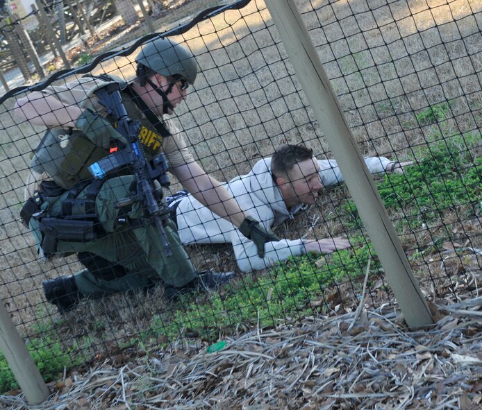 VALDOSTA, Ga. -- A member of the Lowndes County Sherriff’s Office special response operations team restrains a park patron due to his failure to follow orders during a Lowndes County disaster drill held at Wild Adventures Water and Theme Park here March 15. Emergency plans are in place to address situations that may arise and response agencies find it beneficial to practice contingency plans to ensure they are well prepared. (U.S. Air Force photo by Staff Sgt. Schelli Jones/Released)