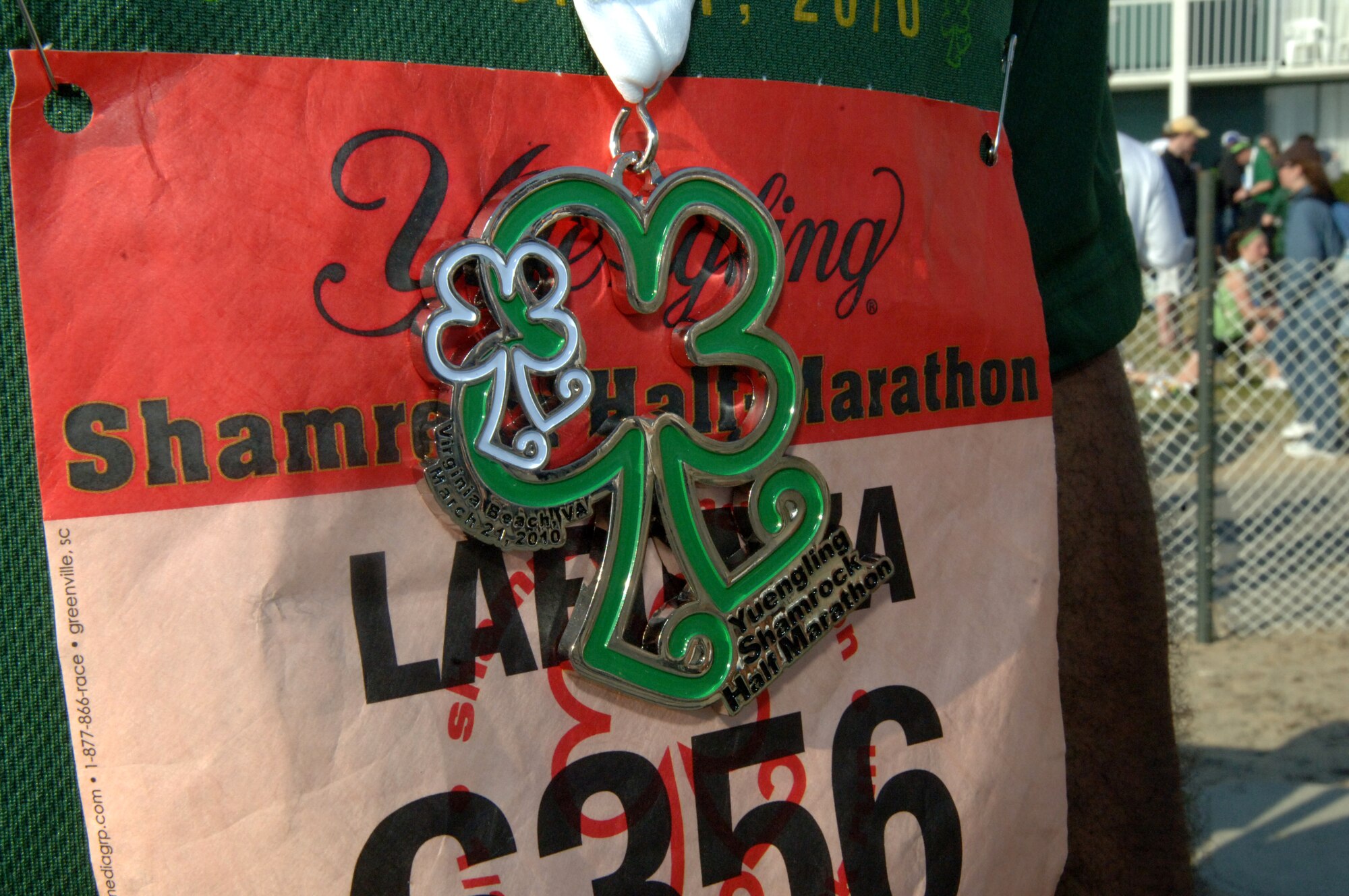 VIRGINIA BEACH, Va. -- Tech. Sgt. Lafonza Spencer, 1st Maintenance Operations Squadron, displays the shamrock-shaped medal received for completing the Yuengling Shamrock Half-Marathon March 21. All participants were given the medal as they crossed the finish line. (U.S. Air Force photo/Airman 1st Class Jason J. Brown)