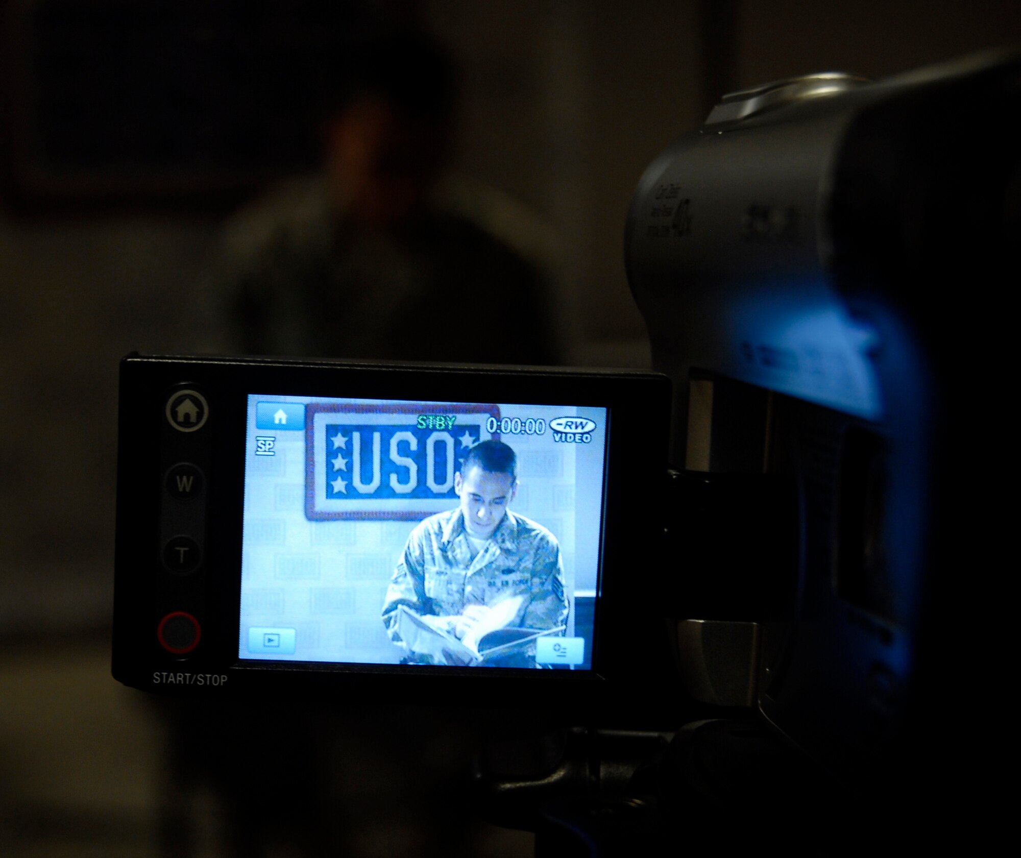 Staff Sgt. Eric Hipp, 1st Special Operations Component Maintenance Squadron, prepares to record himself as he reads a book to his 4-year-old and 1-year-old sons, Ethan and Aiden, for the "United Through Reading" program offered by the USO.  The USO will send the book and the DVD to the sergeant's family during his deployment, which will help keep the bond between parent and child strong. (U.S. Air Force photo by Staff Sgt. Stacy Fowler)