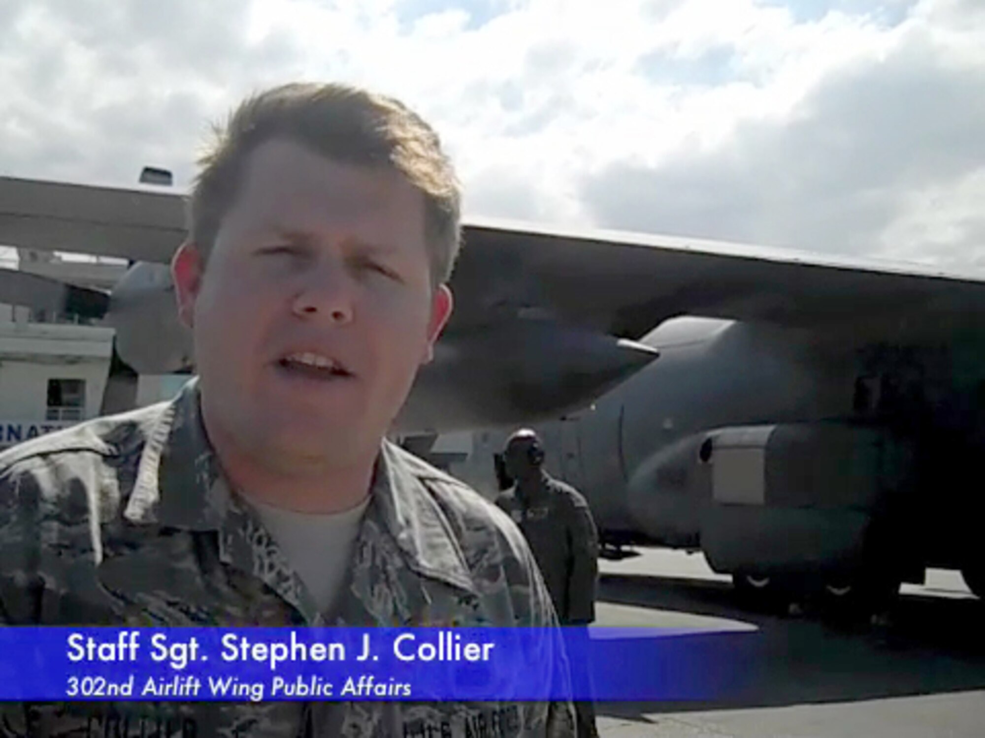 U.S. Air Force Staff Sgt. Stephen J. Collier, a public affairs non-commissioned officer from the Air Force Reserve's 302nd Airlift Wing, conducts one of the wing's video podcasts Feb. 2 while on the ground at Port-au-Prince, Haiti. (U.S. Air Force photo)