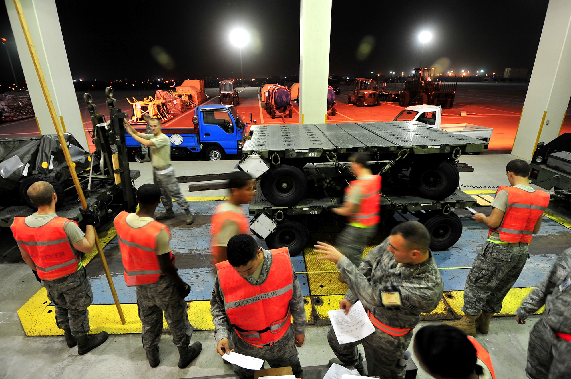 Kadena night-shift members ensure the cargo is weighed correctly and labeled properly before transport for loading during Beverly High 10-02 at Kadena Air Base, Japan, March 22.  The 18th Wing is participating in a Local Operational Readiness Exercise March 22-26 to test the readiness of Kadena Airmen. (U.S. Air Force photo/Tech. Sgt. Rey Ramon) 