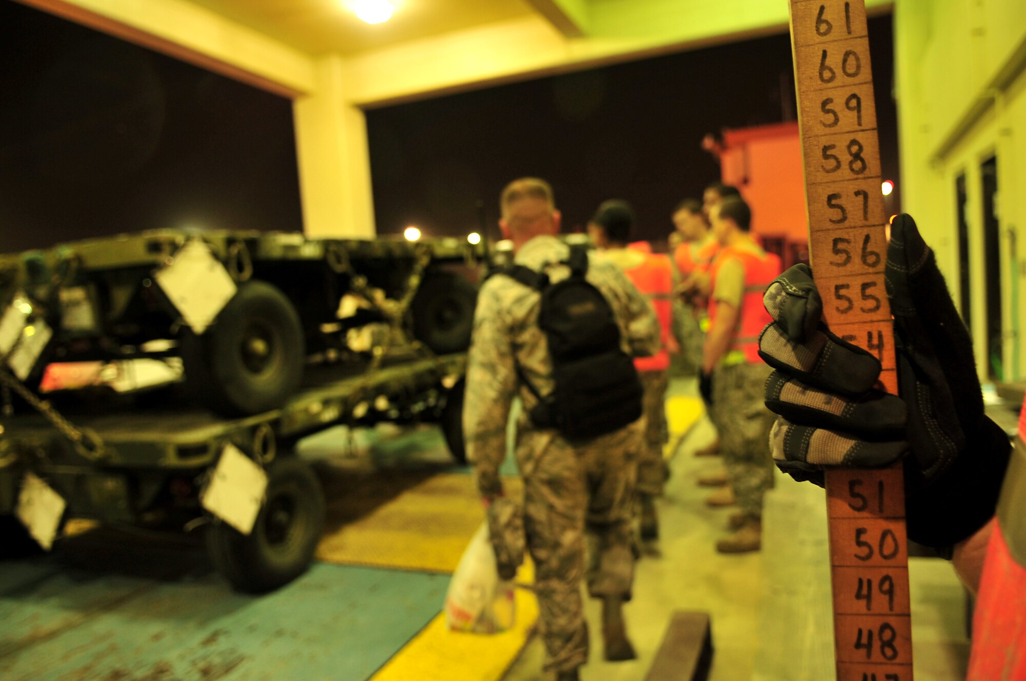 Airman 1st Class Dylan Callow, 18th Logistics Readiness Squadron inbound cargo receiving clerk, uses a large ruler to measure the height and length of the cargo before it is transported for loading during Beverly High 10-02 at Kadena Air Base, Japan, March 22.  The 18th Wing is participating in a Local Operational Readiness Exercise March 22-26 to test the readiness of Kadena Airmen. (U.S. Air Force photo/Tech. Sgt. Rey Ramon)  